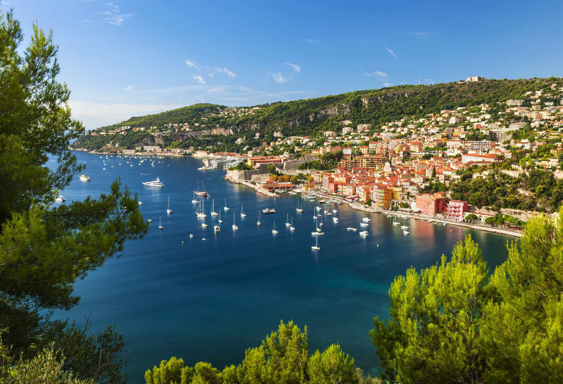 Aerial view of scenic French Riviera mediterranean coast with medieval coastal town Villefranche-sur-Mer, Cap de Nice and leisure boats anchored in harbor; Shutterstock ID 298640480