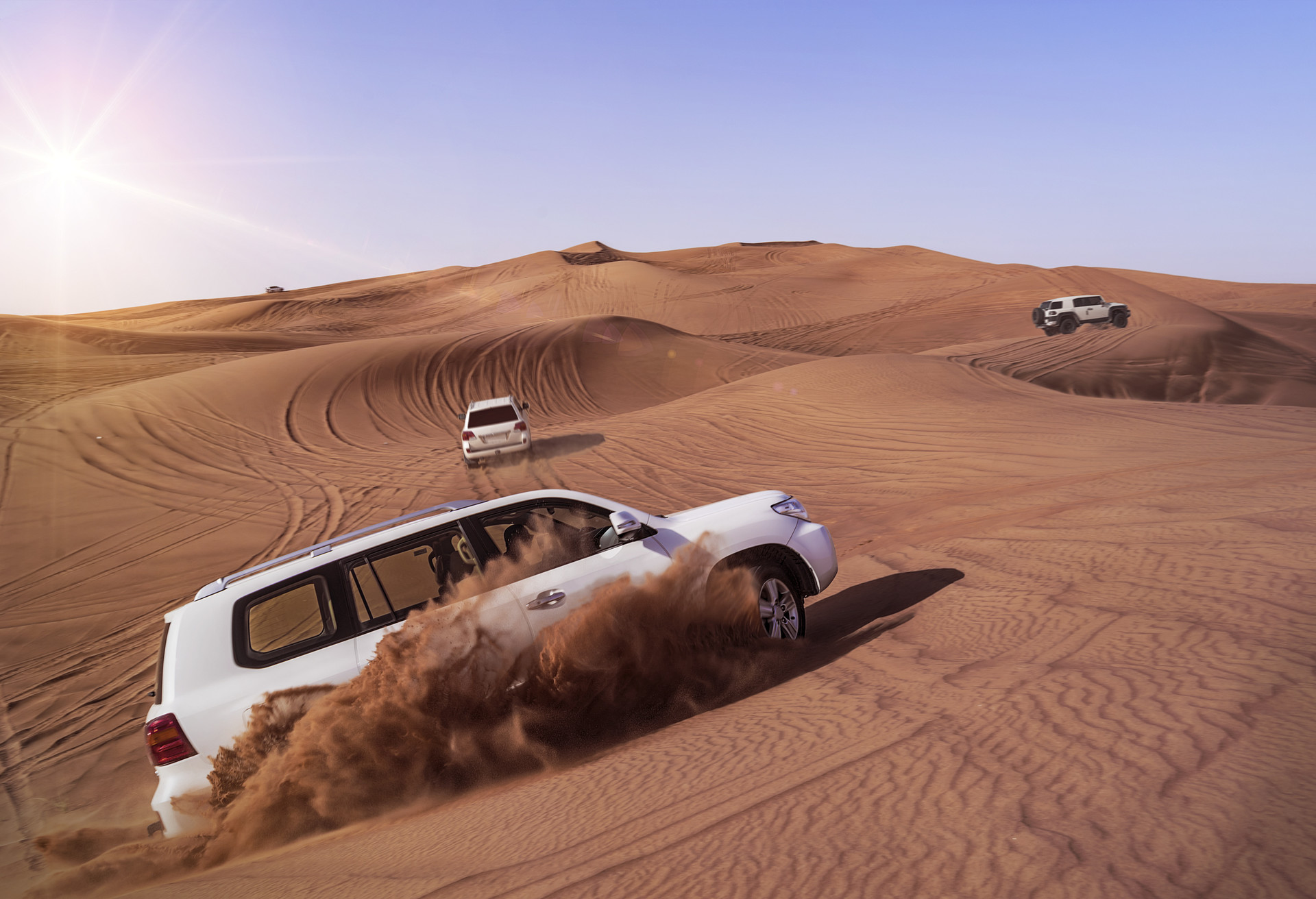 Desert Safari SUVs bashing through the arabian sand dunes; Shutterstock ID 401671129