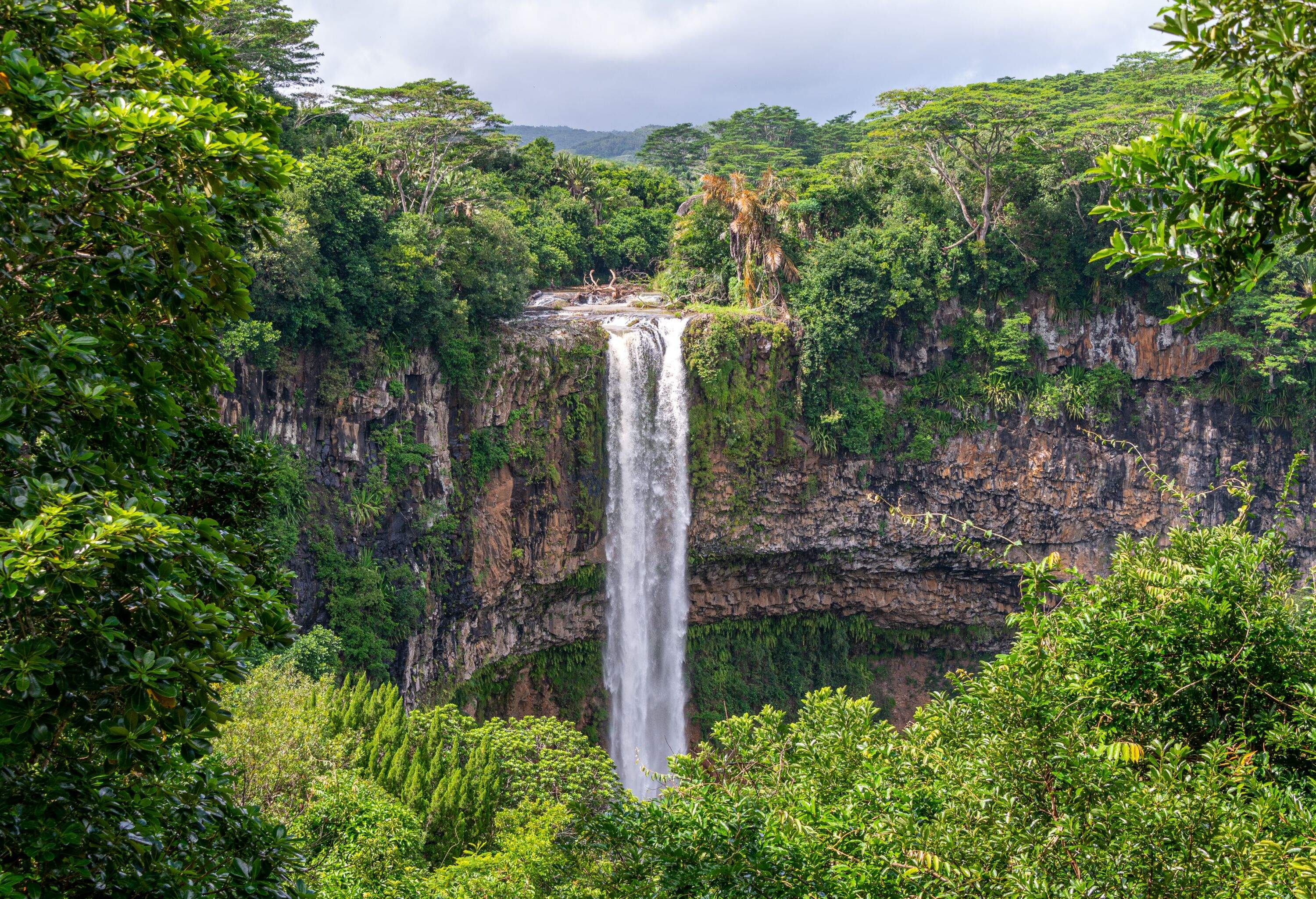 The Chamarel Waterfalls on the Indian Ocean island of Mauritius are 90m high and fall from the River St Denis in the Black River Mountains to form the River du Cap below.