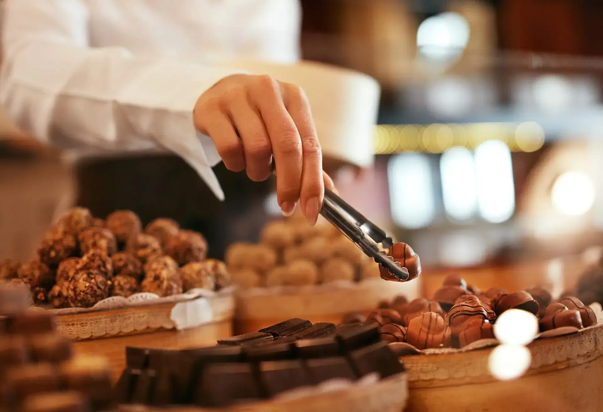 A woman picking some chocolate candy