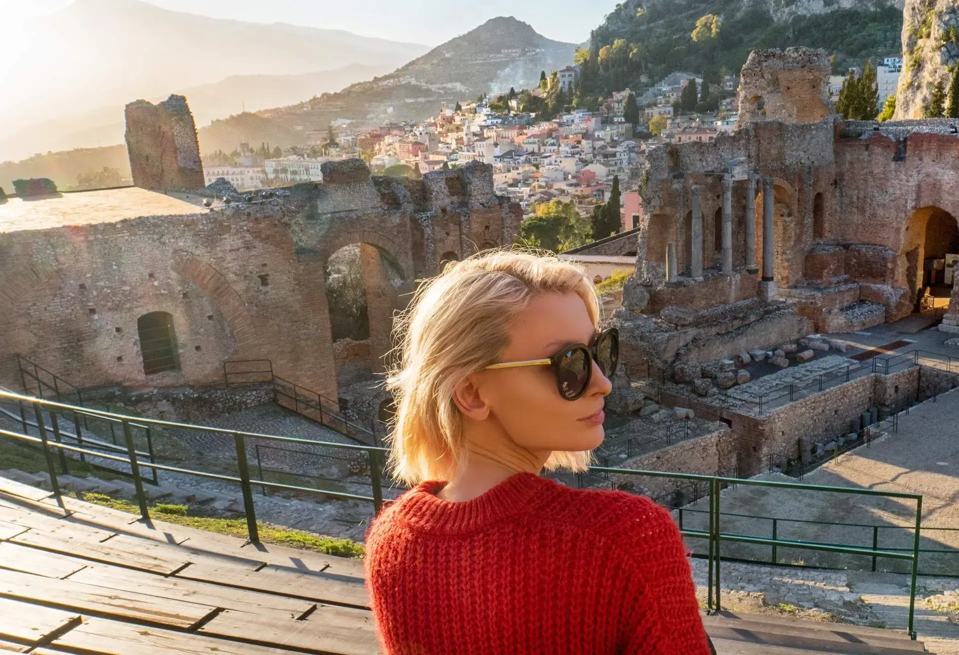 Landscape of the ancient theatre of Taormina. Greek theatre and Etna volcano, southern Italy.Blonde woman sightseeing