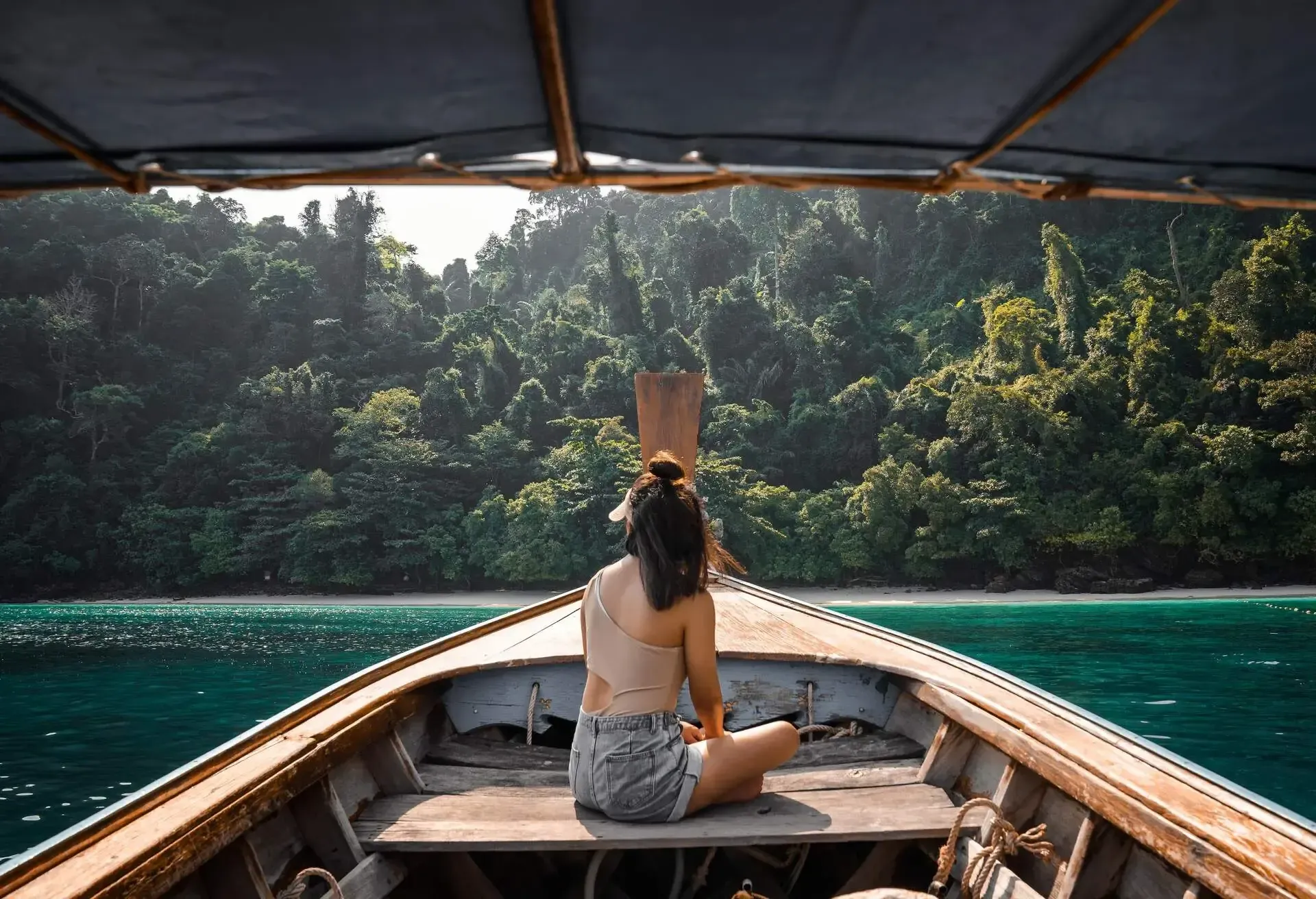 Tourists young Asian woman on long tailed boat at Koh Phi Phi island, Phuket, Thailand.
