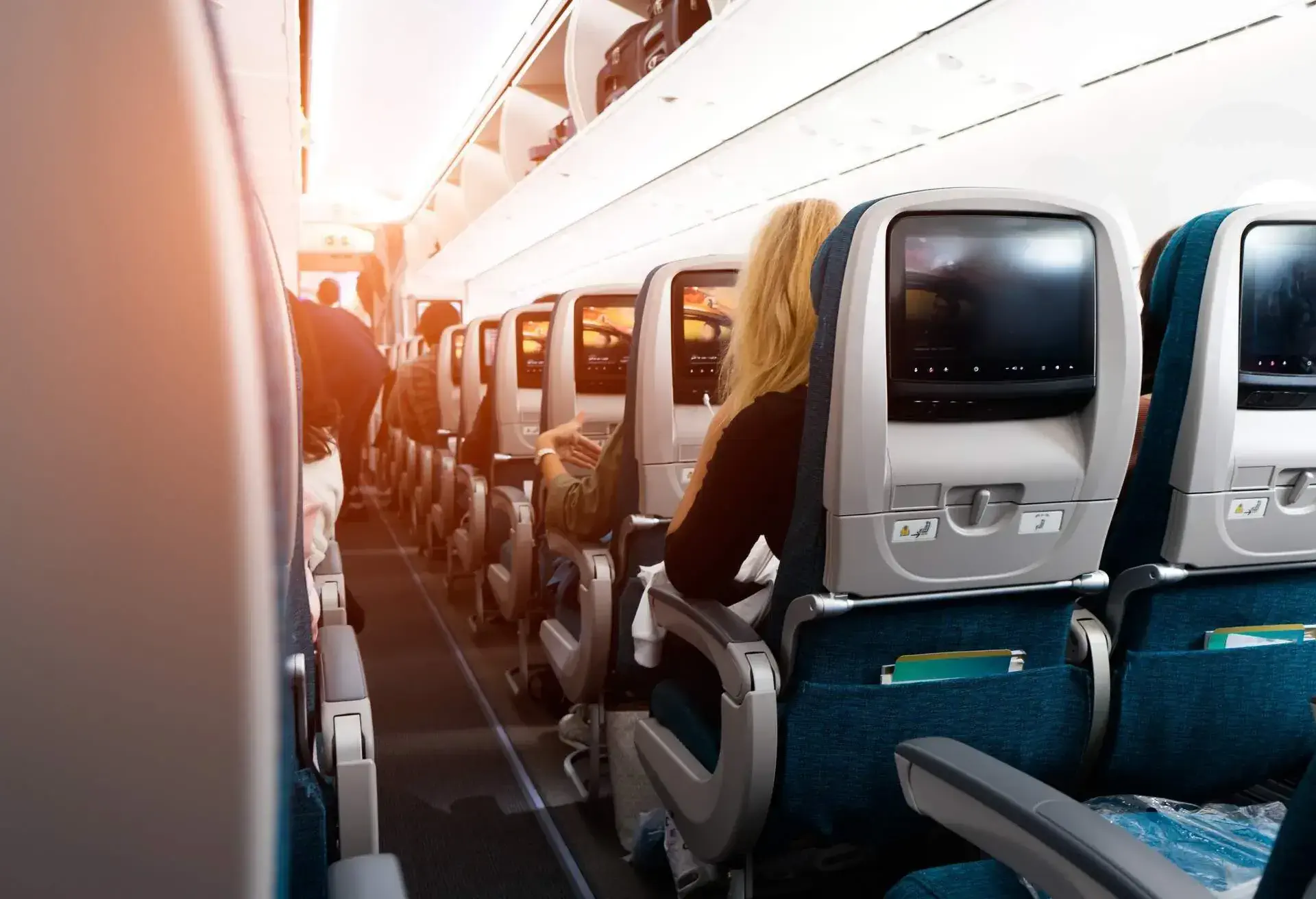 People seating on a plane in the last rows