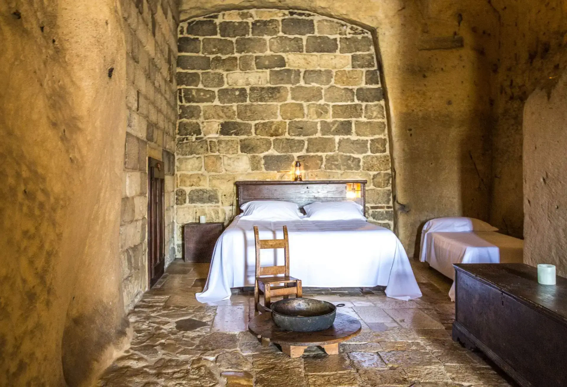 A photo of a hotel room in a cave in Matera, Italy.