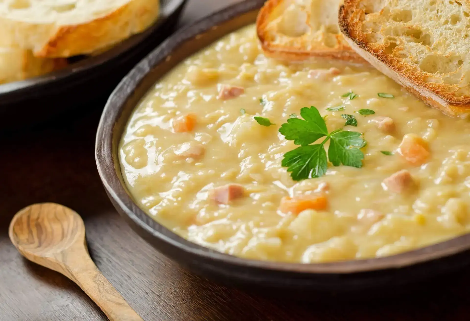 Bowl of Canadian split pea soup with two slices of toasted bread