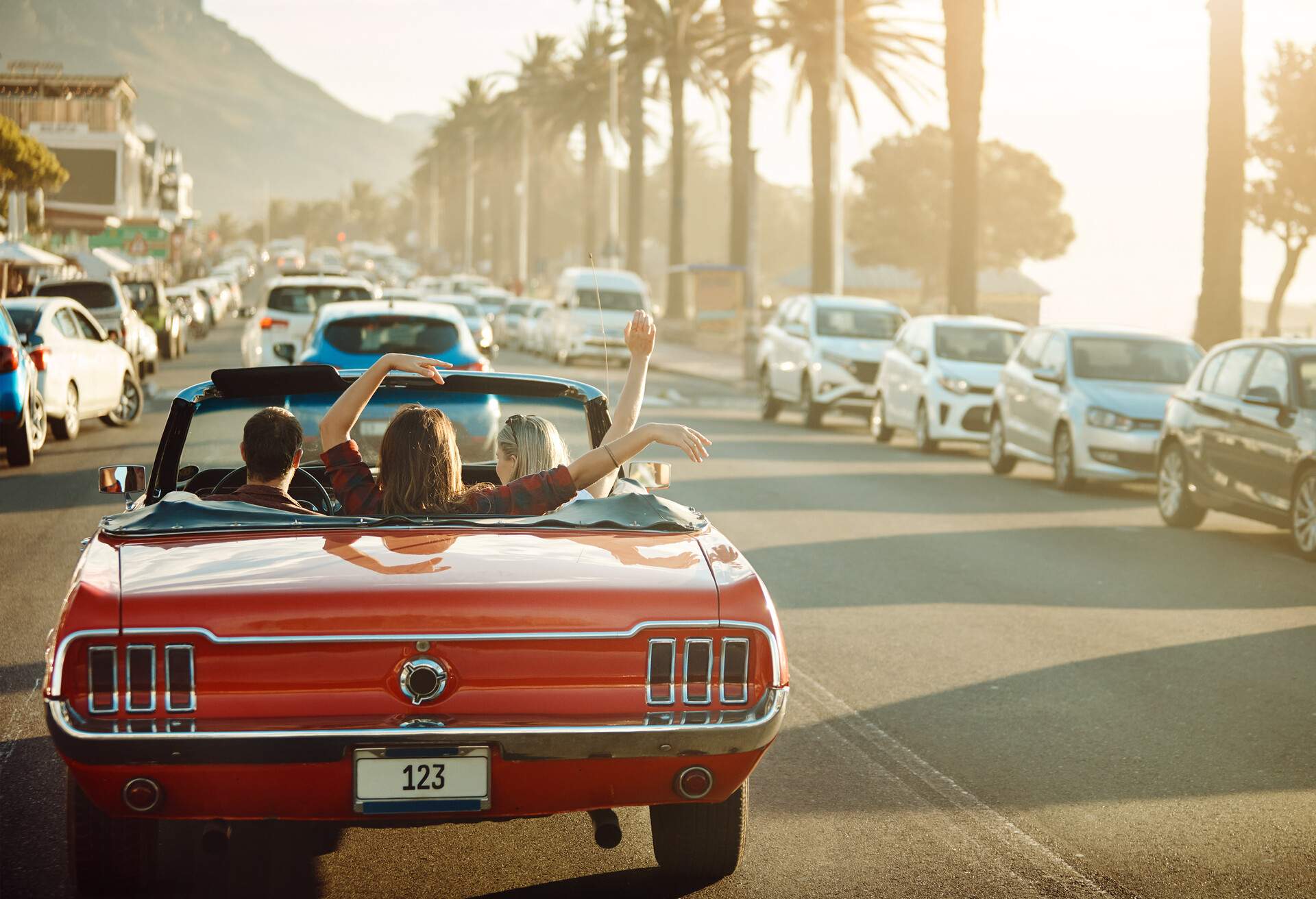 THEME_CAR_VEHICLE_CONVERTIBLE_SUNSET_PEOPLE_VACATION-GettyImages-1148606069