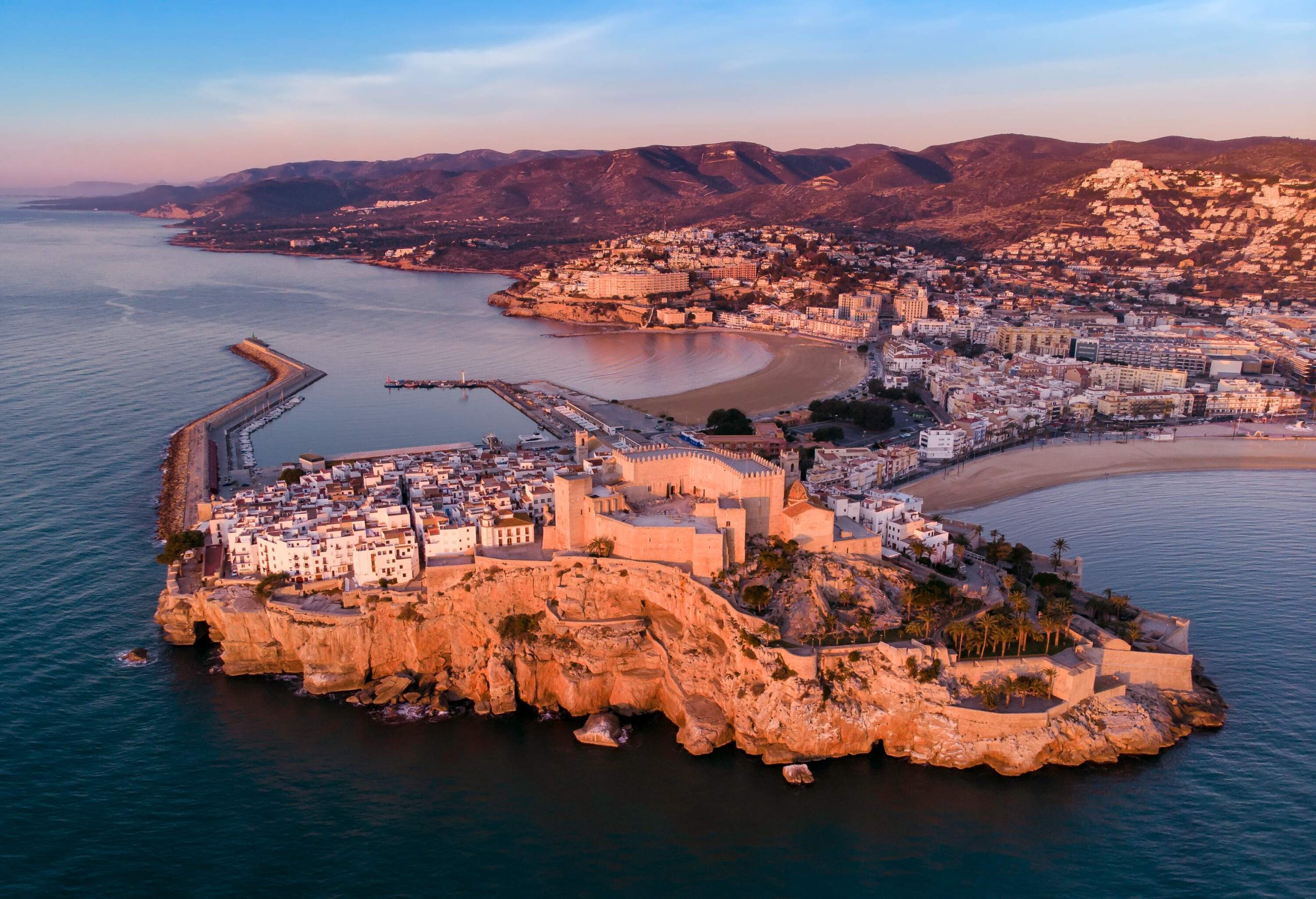 A medieval castle among the whitewashed classic buildings, perched on a rocky headland with a panoramic view of the Mediterranean Sea.