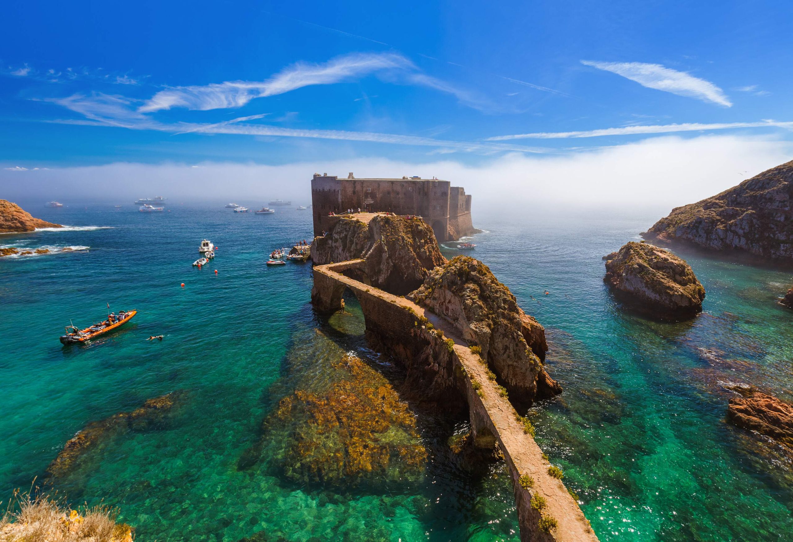 The Fort of the Berlengas stretches to the sea and accessed through a narrow-path bridge across the pristine waters with sailing boats.