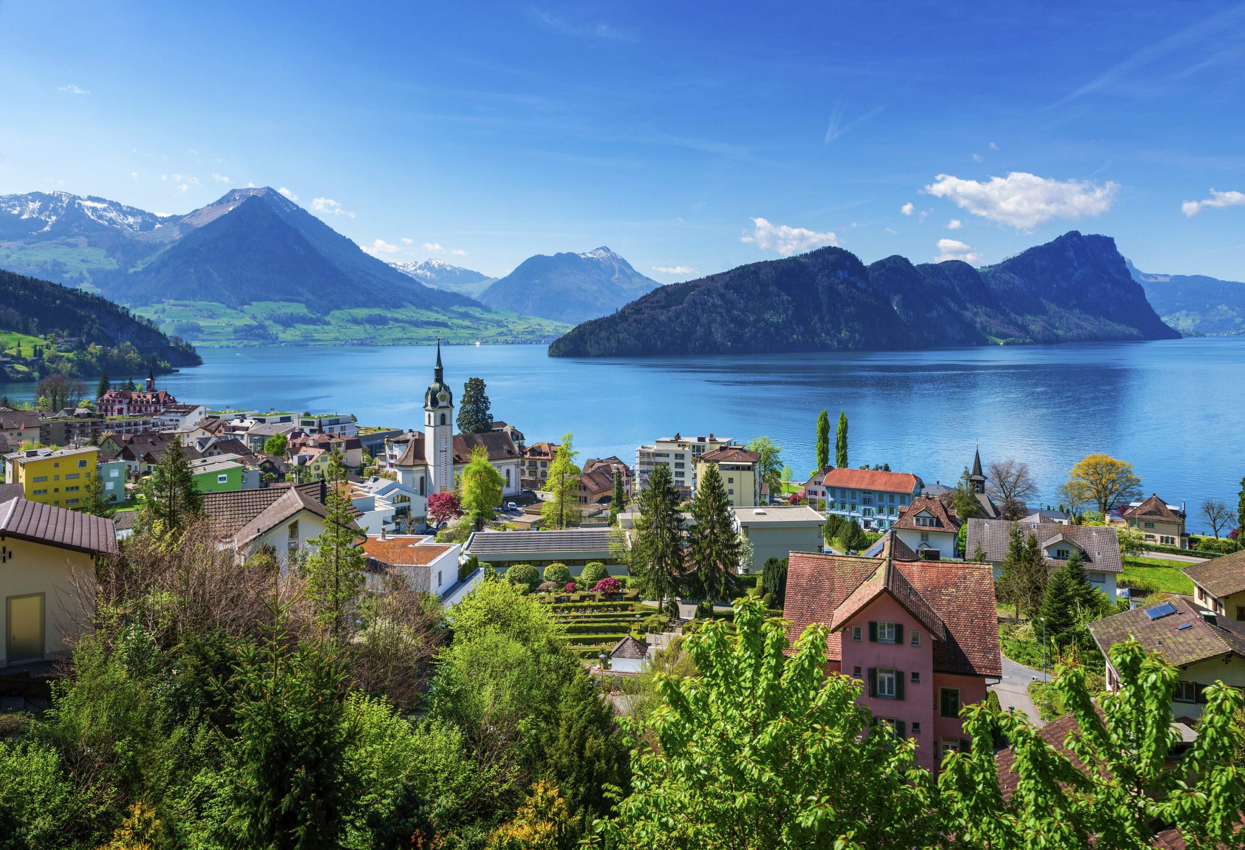 A lovely lakeside village surrounded by mountains and hills.