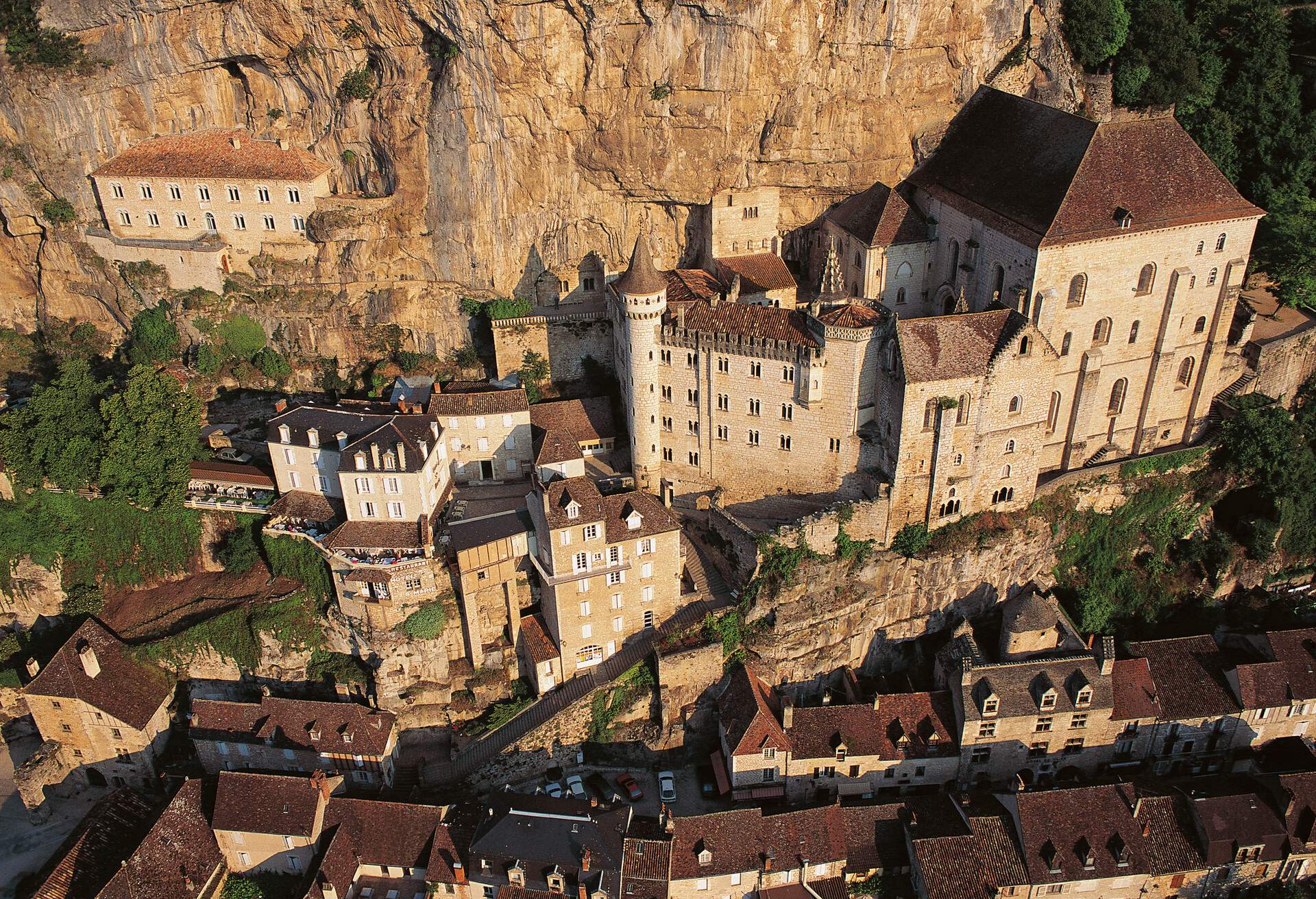 Tiny houses surround the sanctuary of the Blessed Virgin Mary, accessed by a staircase in a village that clings to a cliff.