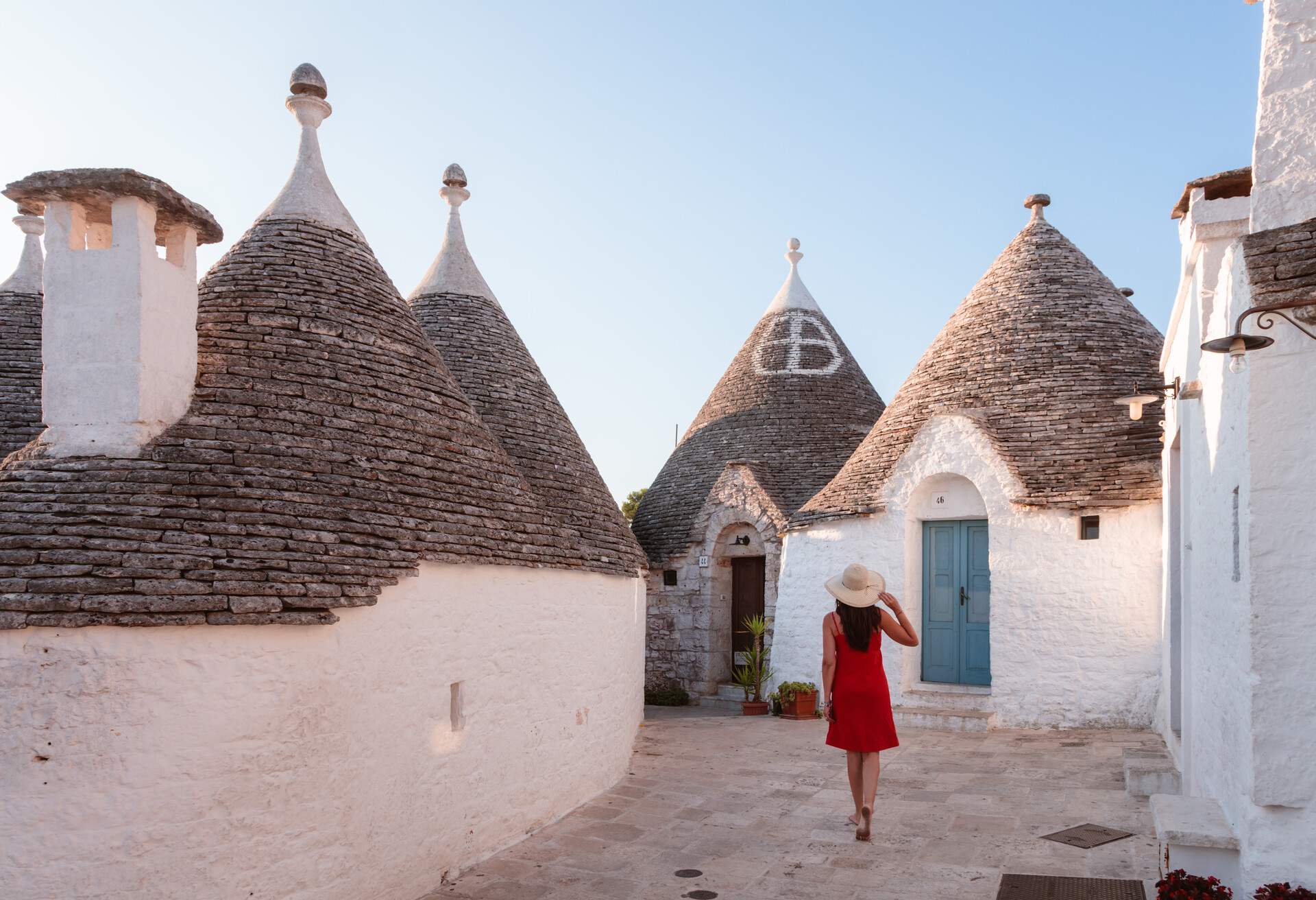 Woman visiting the Trulli area, Alberobello, Itria valley, Apulia, Italy