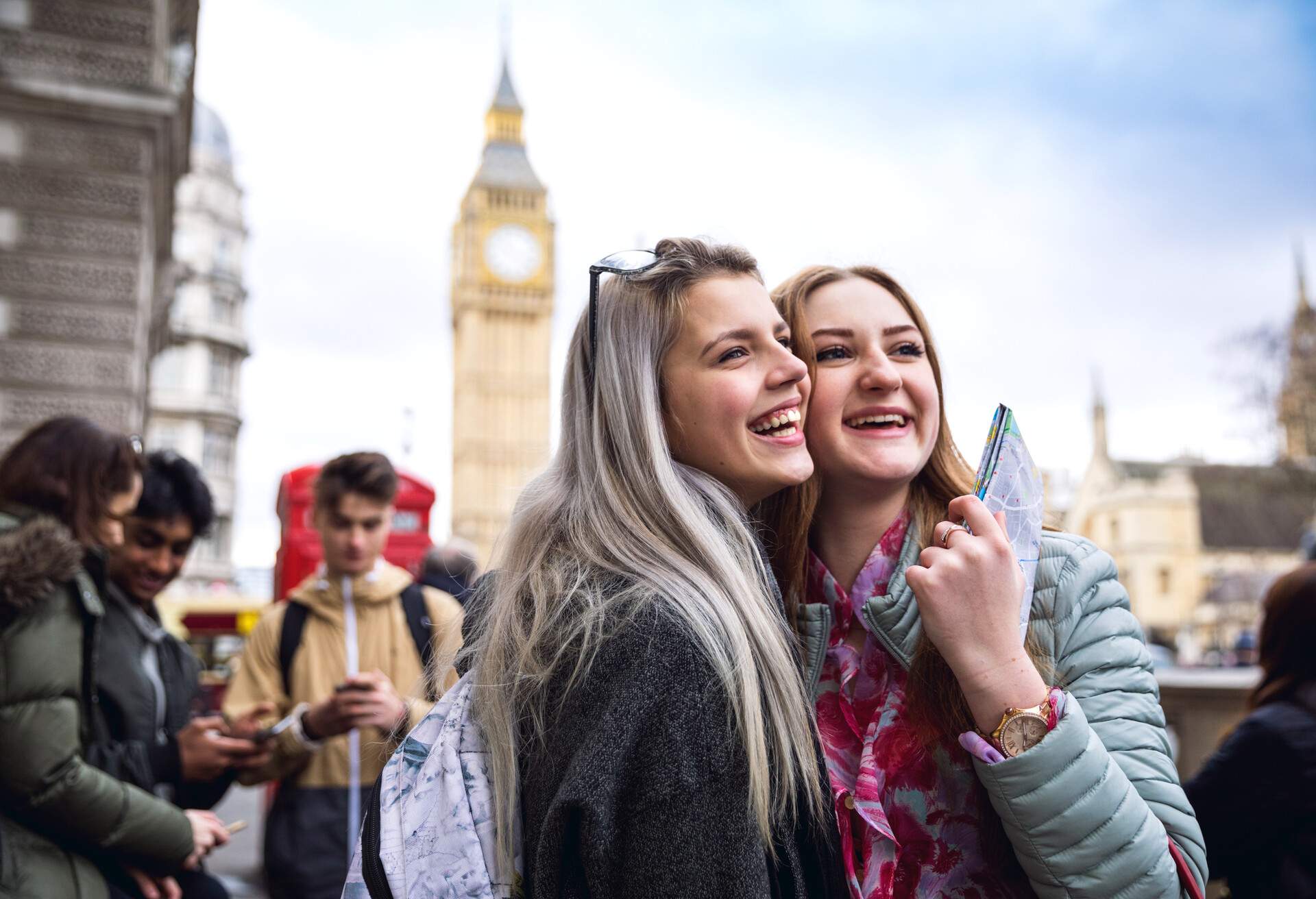 Group of young teenagers enjoying a school trip in London, visiting Westminster areas.