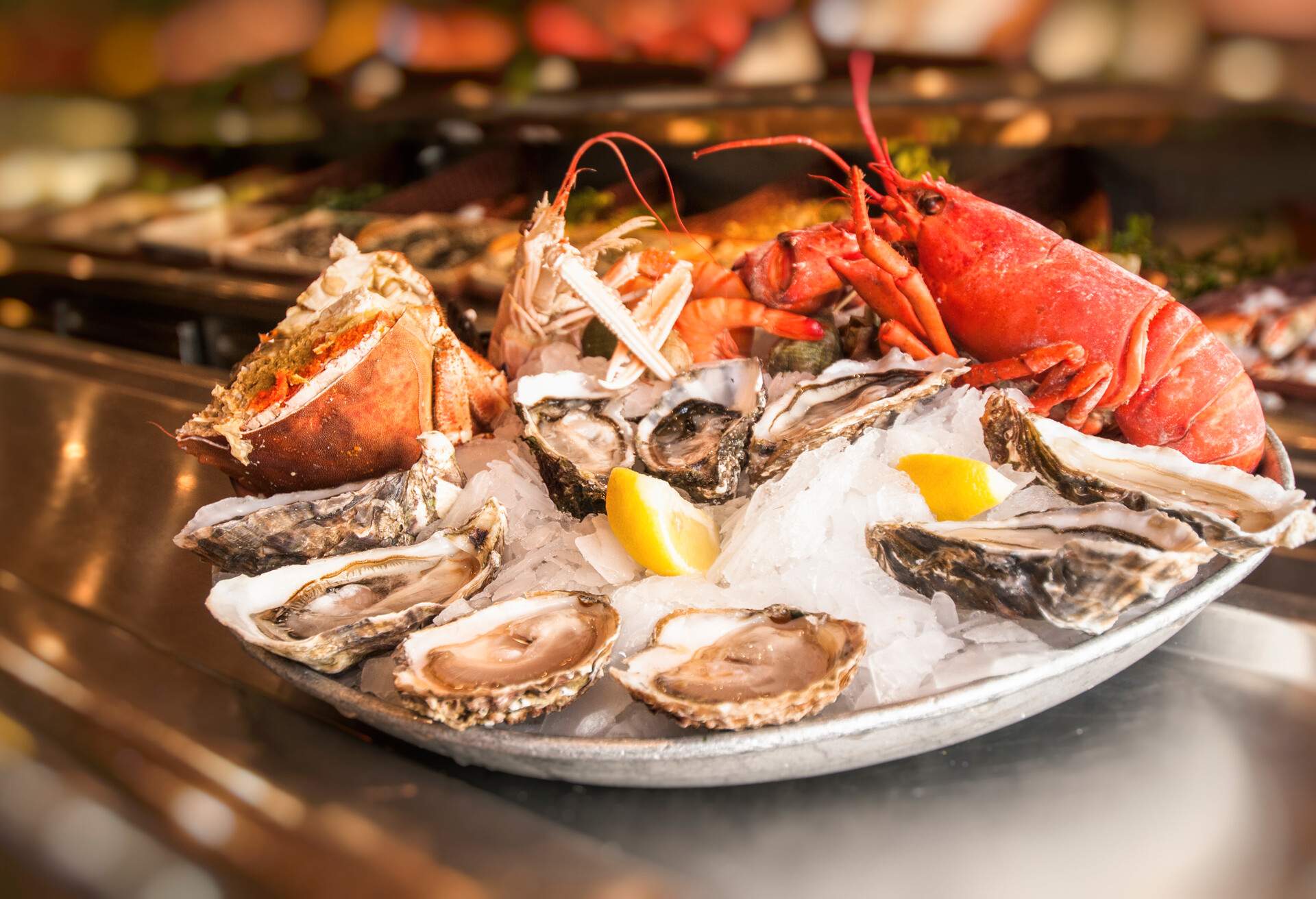 A fresh seafood platter with oysters, crabs, prawns, and lobsters.