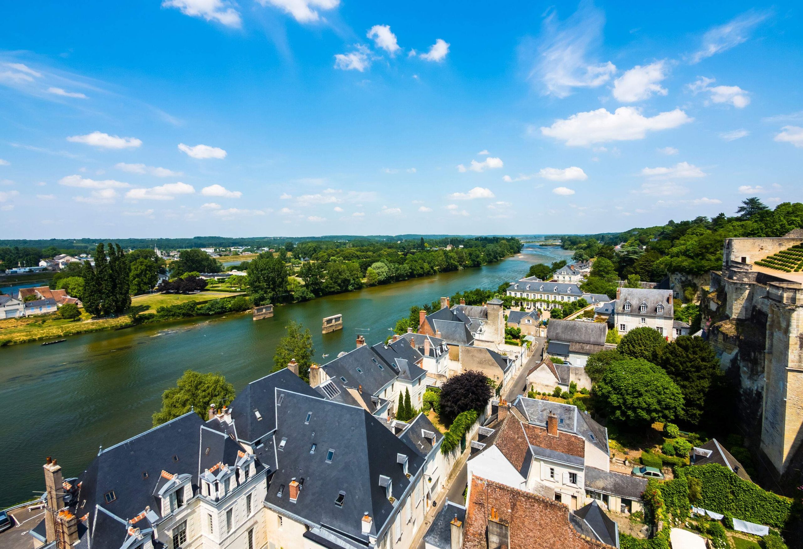 A river along a cluster of town buildings.