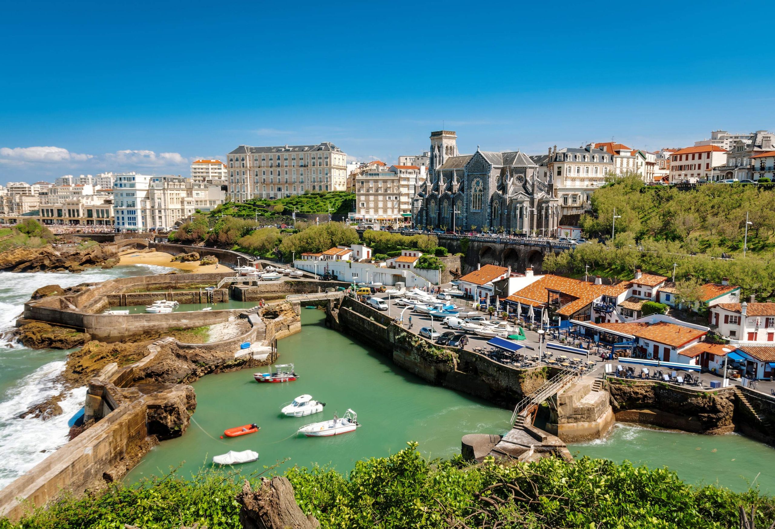 A picturesque seaside town lined with classic elegant buildings and a port.