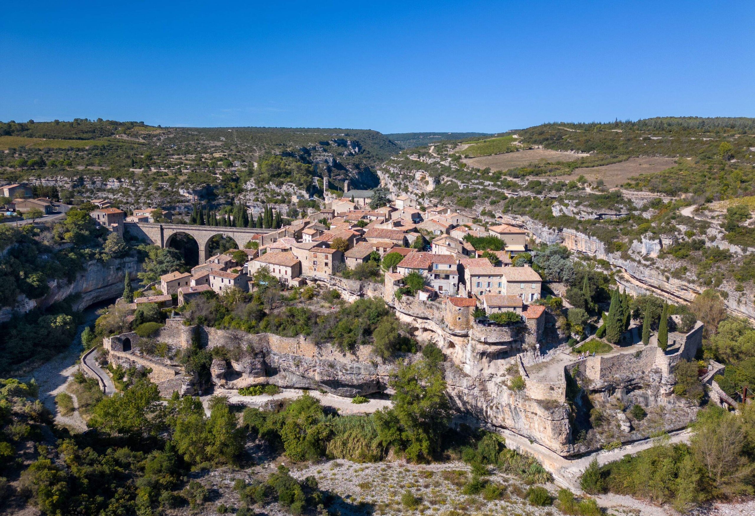 This aerial drone photo shows the small village of Minerve in the region of Beziers. The town is known for the canyon that goes around the town which was created by the river La Cesse.