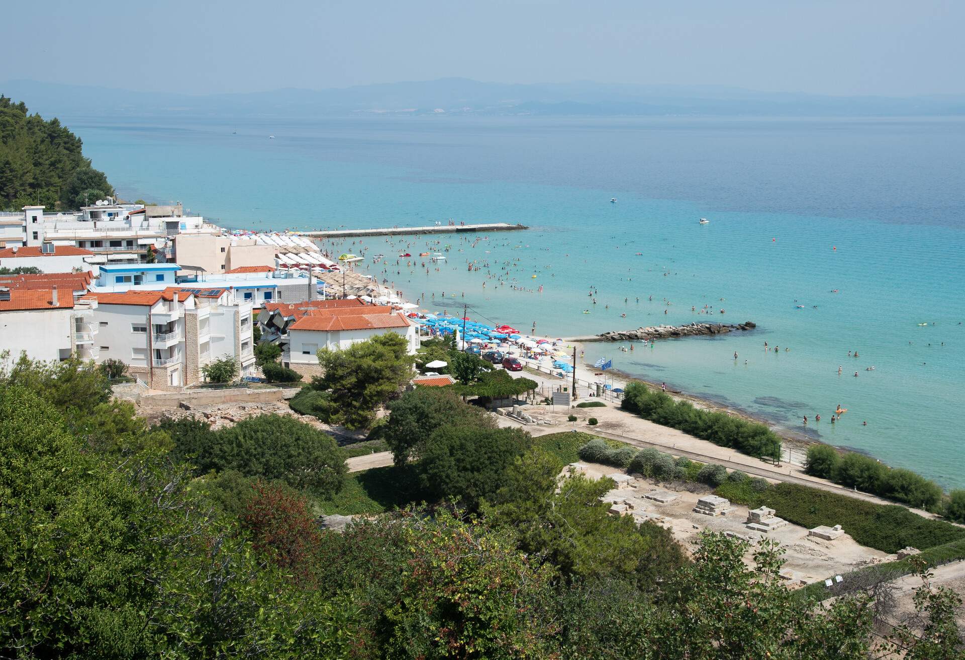 Chalkidiki, Greece- July 26 2017: Panoramic view of famous and idyllic beach of Kalithea with people swimming, resting and enjoying their summer vacations  Kassandra Peninsula in Chalkidiki, Greece