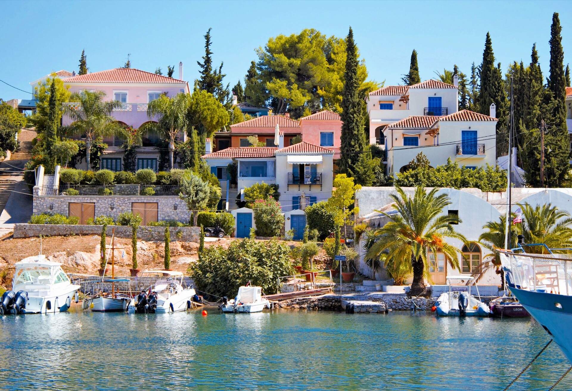 Scenic in the old harbor of Spetses island, Greece, with fishing boats and beautiful mansions, September 24 2015.
