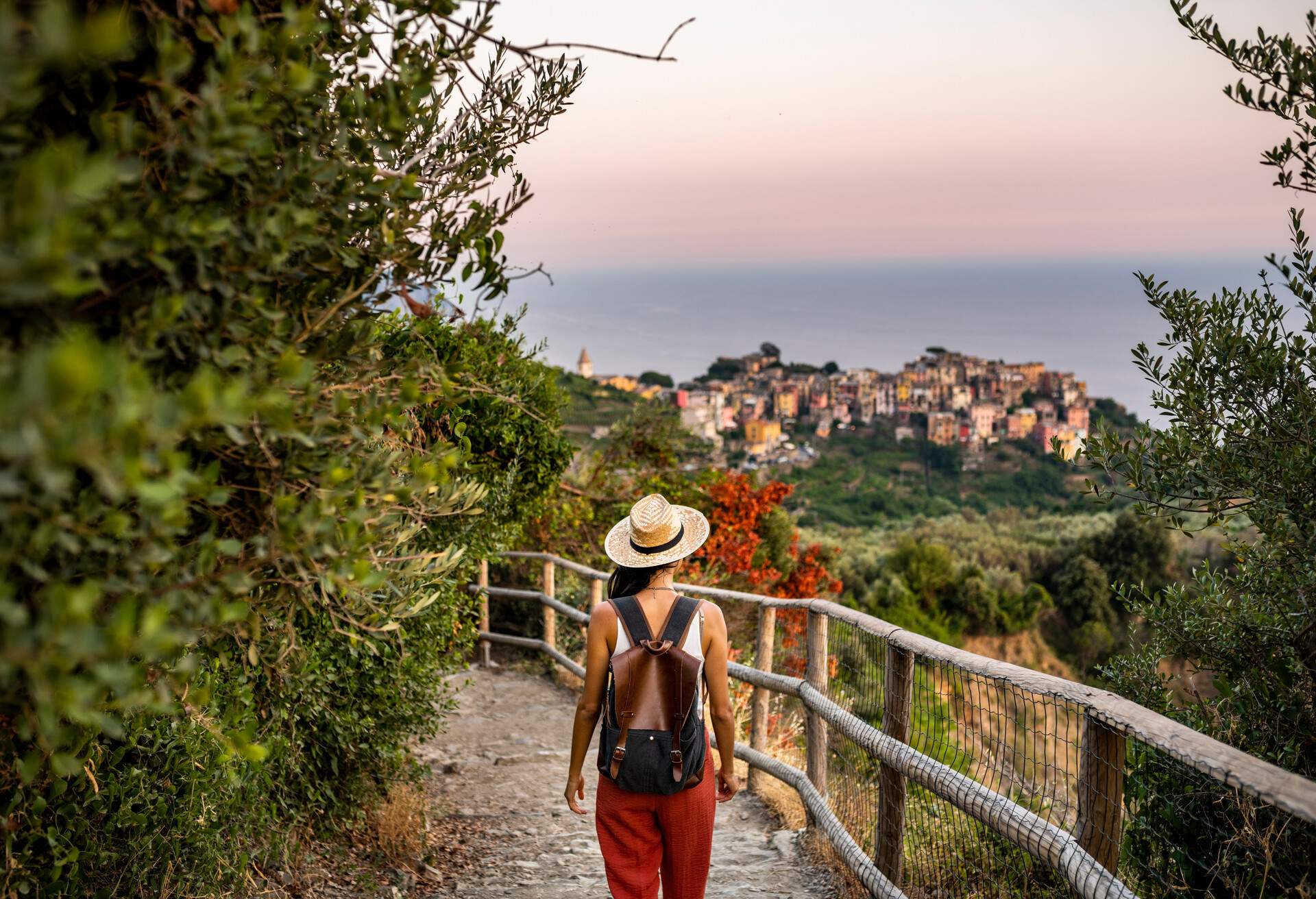 Female tourist walking towards Corniglia village, Beautiful town in Cinque Terre coast