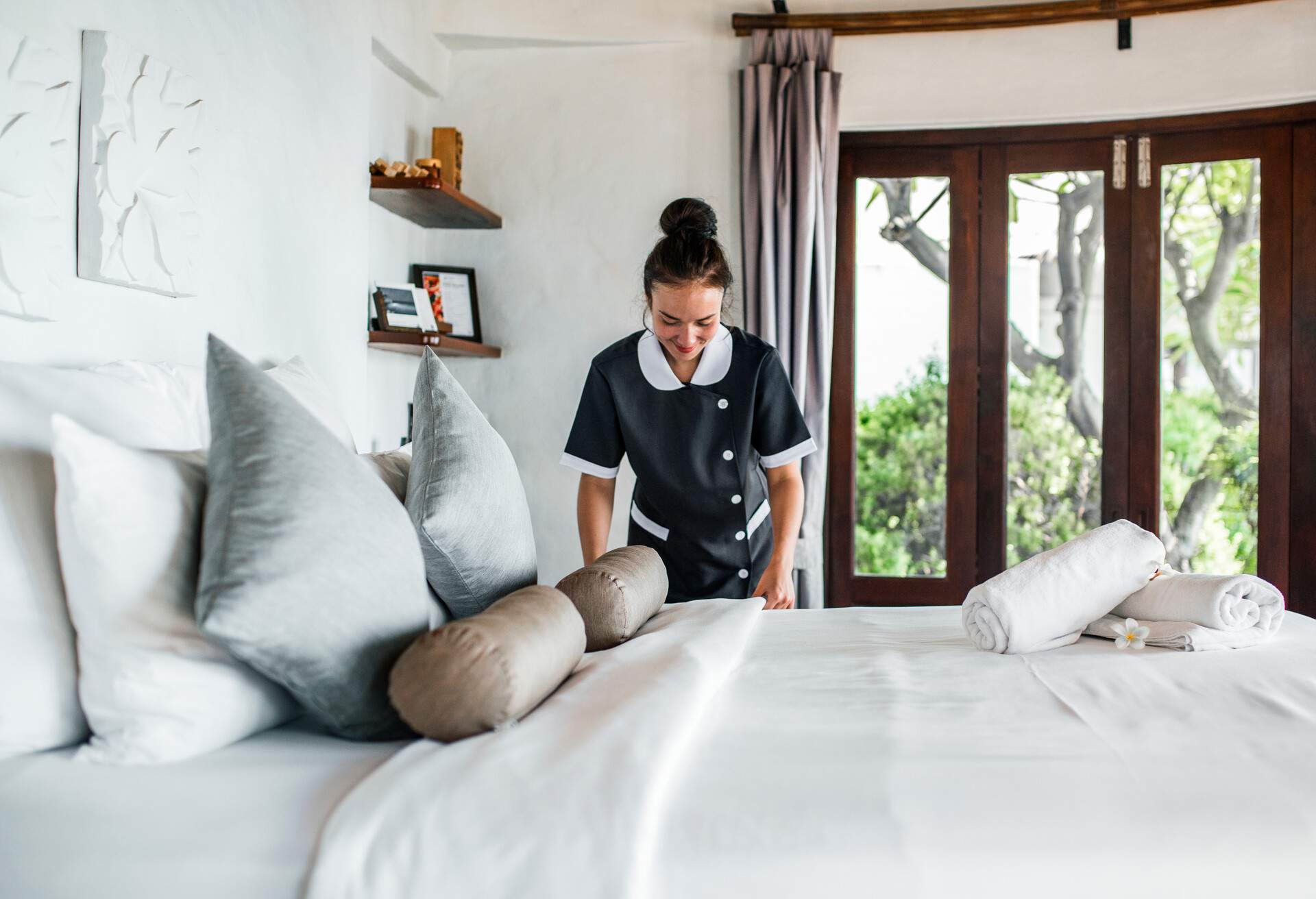 Housekeeper cleaning a hotel room; Shutterstock ID 1102215473; Purpose: Hotel/Categories; Brand (KAYAK, Momondo, Any): KAYAK