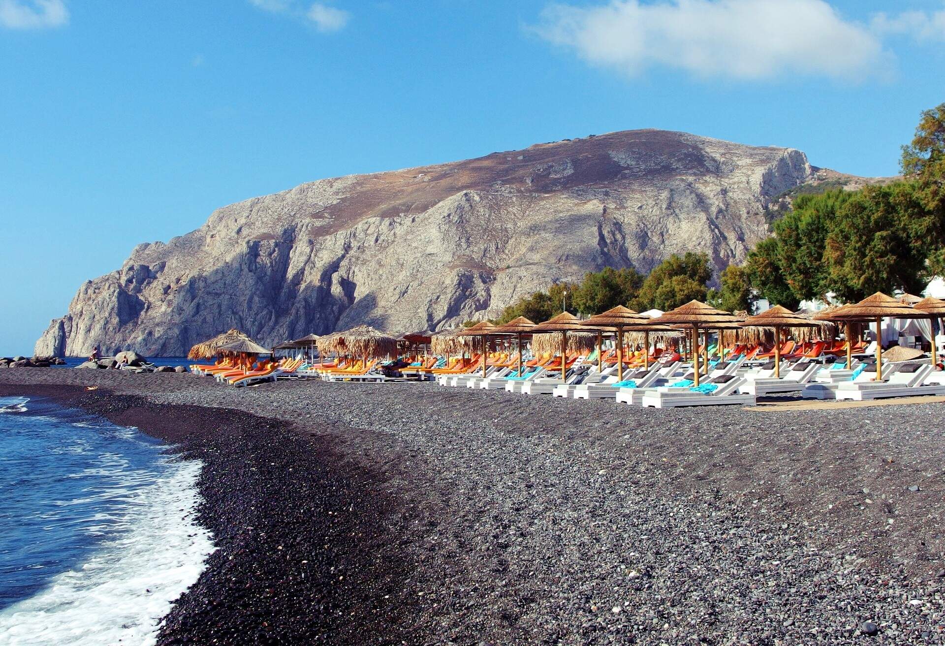 beach in Kamari town on Santorini island, Greece; Shutterstock ID 695234206