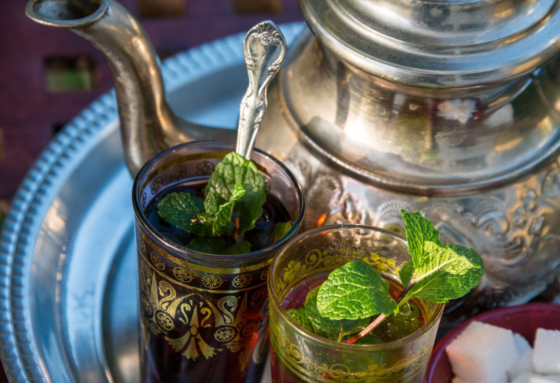 Glasses with tea and traditional Moroccan teapot