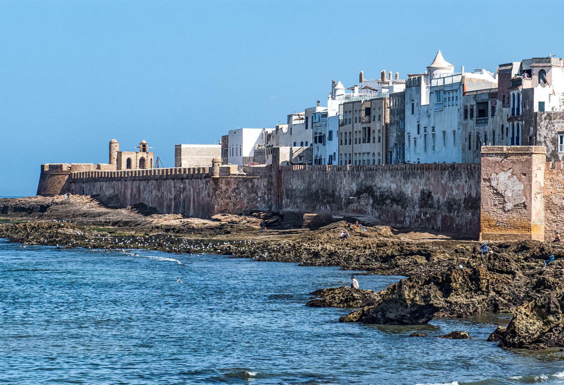 The ancient ramparts of the coastal town of Essaouira, Morocco. The fortress walls surround the old medina of Essaouira. The town is famous for its blue colours, especially the blue fishing boats.; Shutterstock ID 1048165273