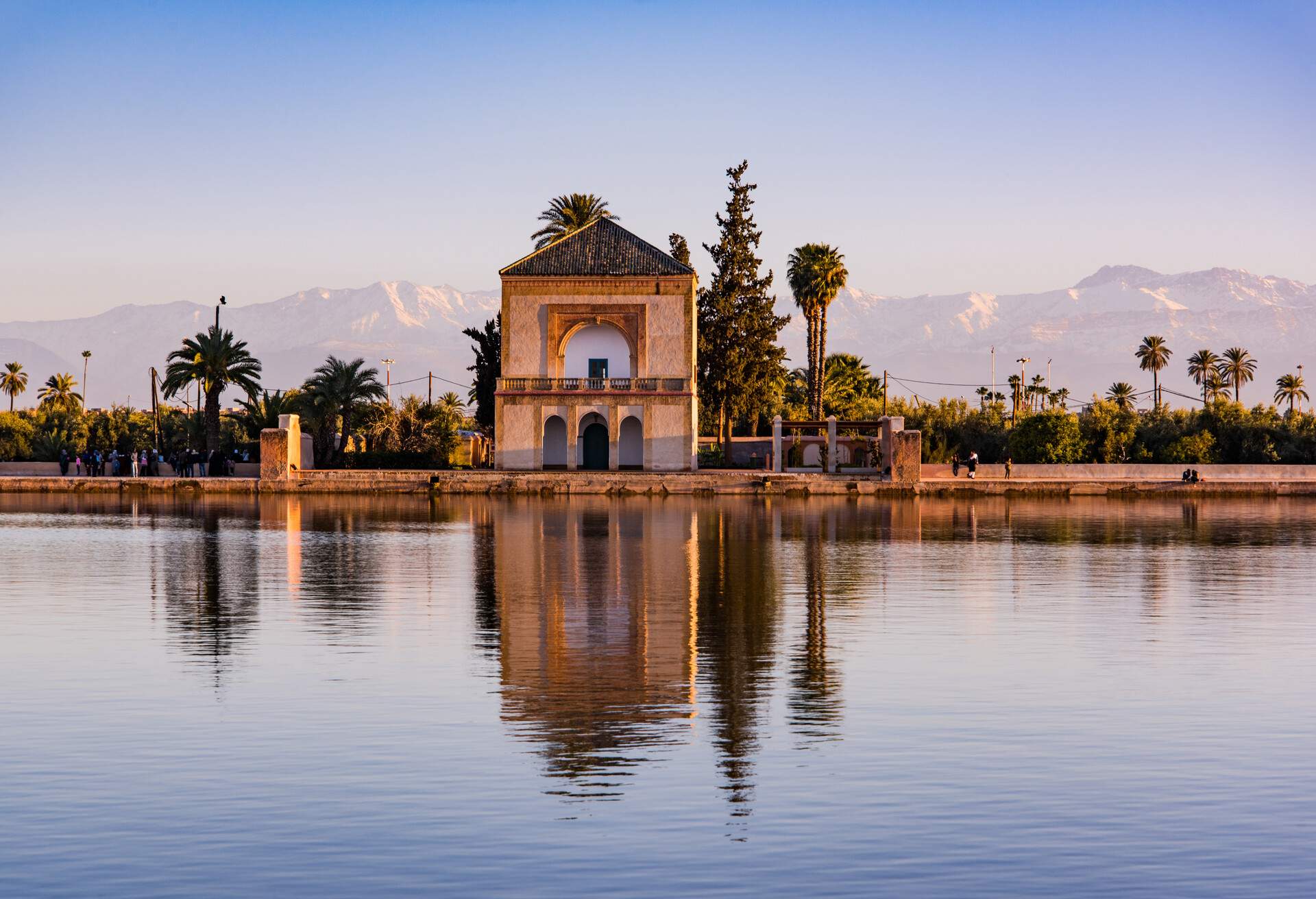 Saadian pavilion,Menara gardens and Atlas in Marrakech, Morocco, Africa at sunset. Water reflection.