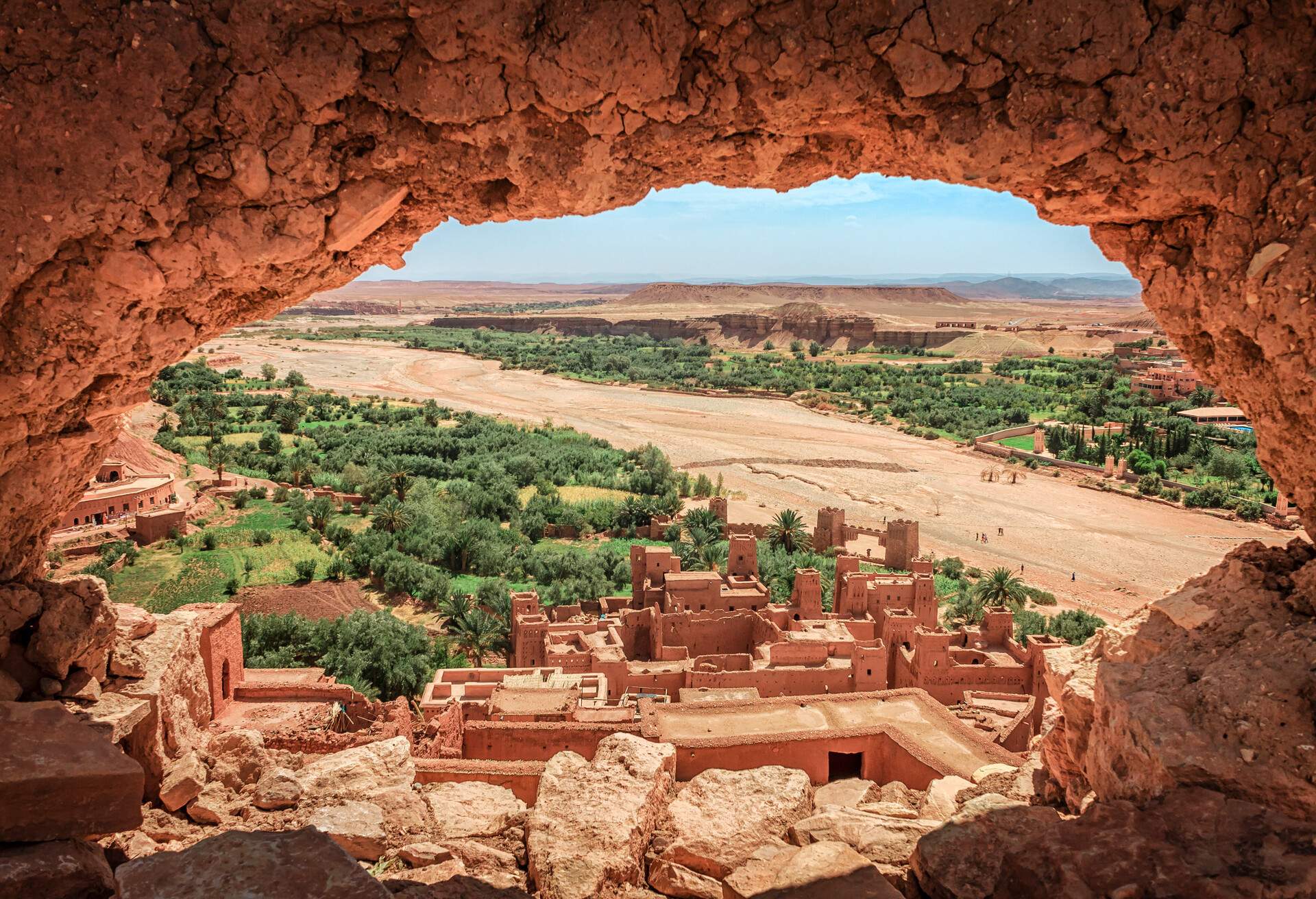 Popular point of view of the valley of the desolating river Onila through a hole in a wall of Ancient Kasbah in Ait-Ben-Haddou, Morocoo. Famous ancient berber kasbah. near Ouarzazate city in Morocco; Shutterstock ID 1283004388; purchase_order: ; job: ; client: ; other: