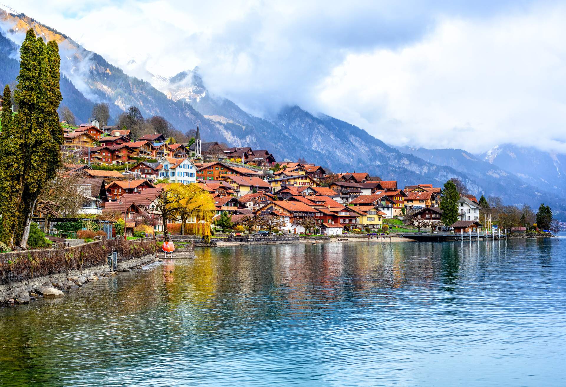 Old town of Oberried, Brienz, Interlaken and misty Alps mountains reflecting in lake, Switzerland