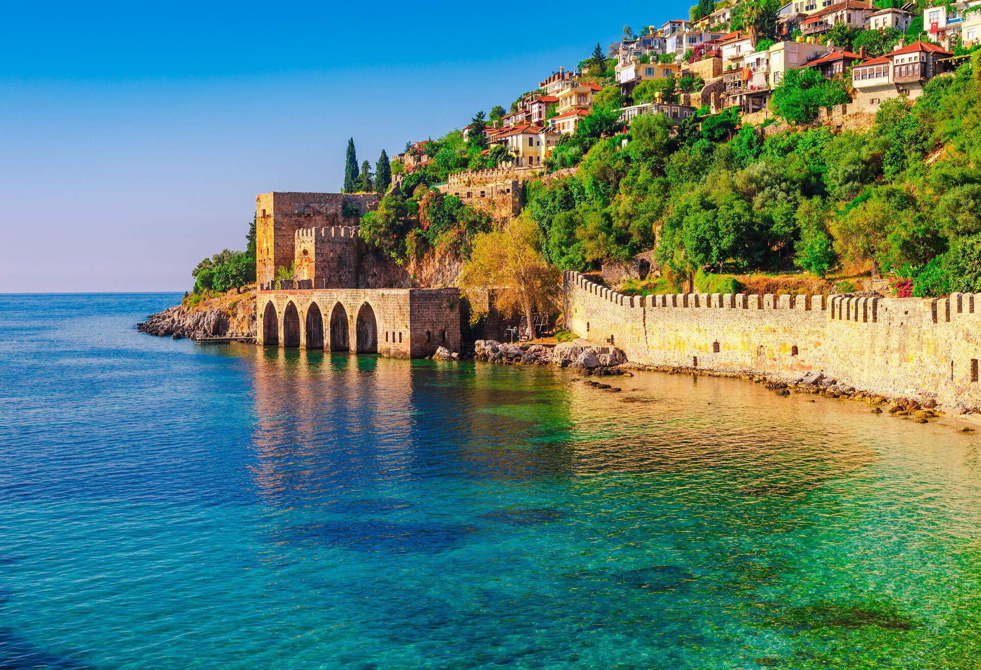 Landscape of ancient shipyard near of Kizil Kule tower in Alanya peninsula, Antalya district, Turkey, Asia. Famous tourist destination with high mountains. Part of ancient old Castle.; Shutterstock ID 613452113; Purchase Order: SF-06928905; Job: ; Client/Licensee: ; Other: