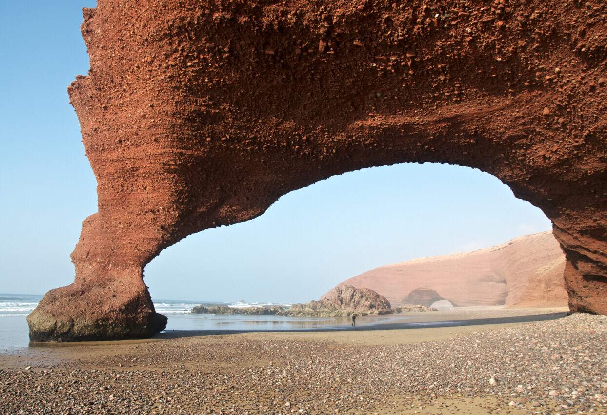 Natural Arch At Beach Against Sky