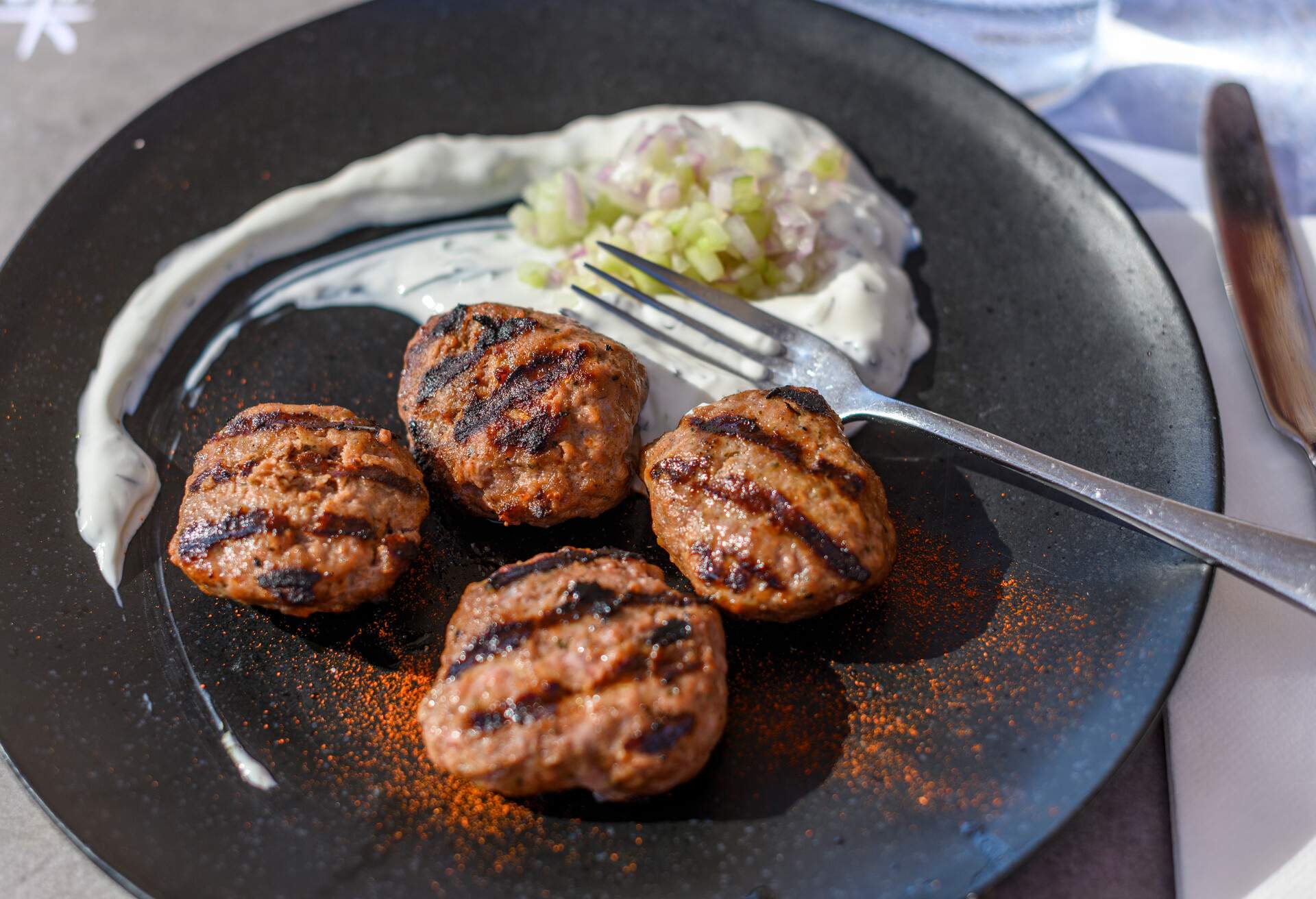 Delicious Greek meatballs served on the black plate.