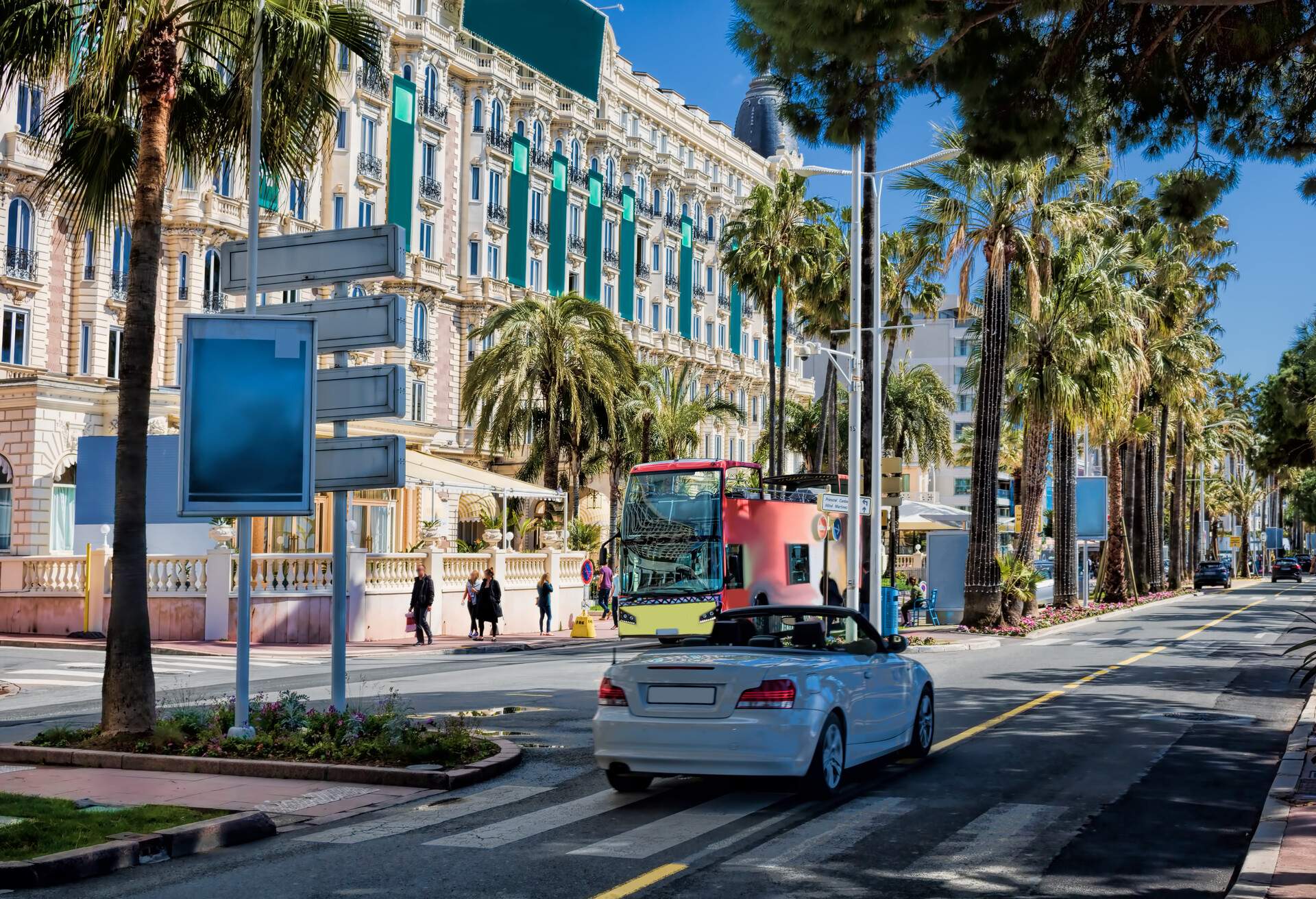 Luxurious structures along a palm-tree lined boulevard.