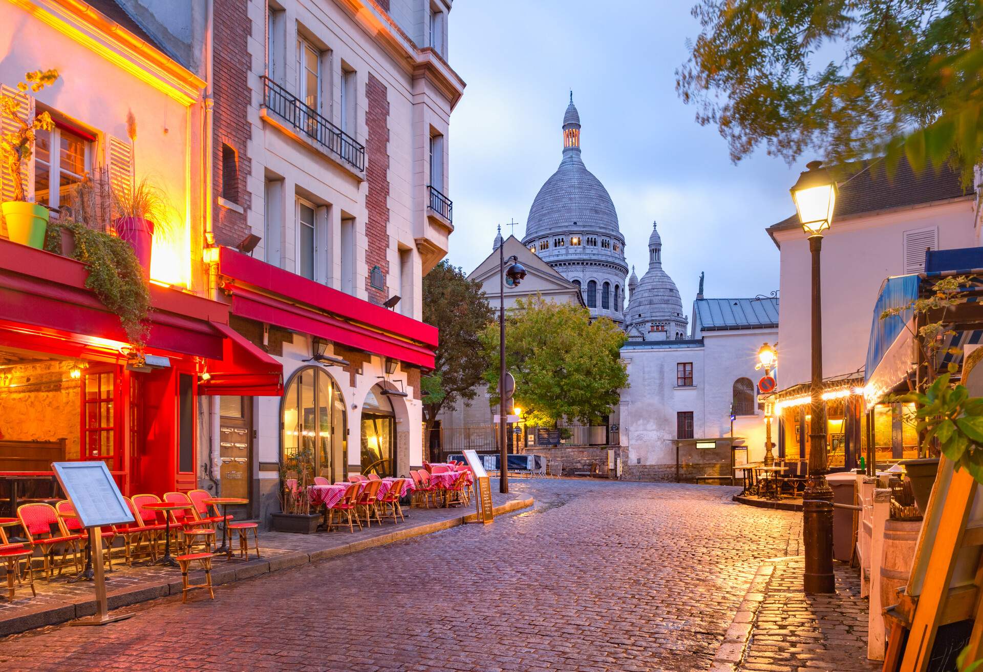 The Place du Tertre with tables of cafe and the Sacre-Coeur in the morning, quarter Montmartre in Paris, France