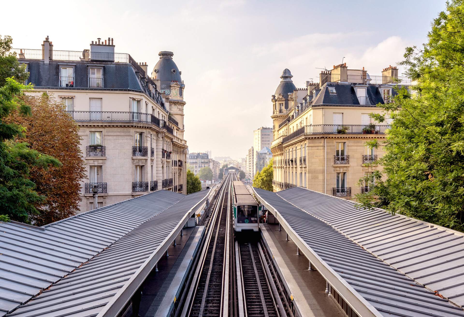 Paris metro is leaving Passy Station and crossing Pont de Bir-Hakeim, Paris, France