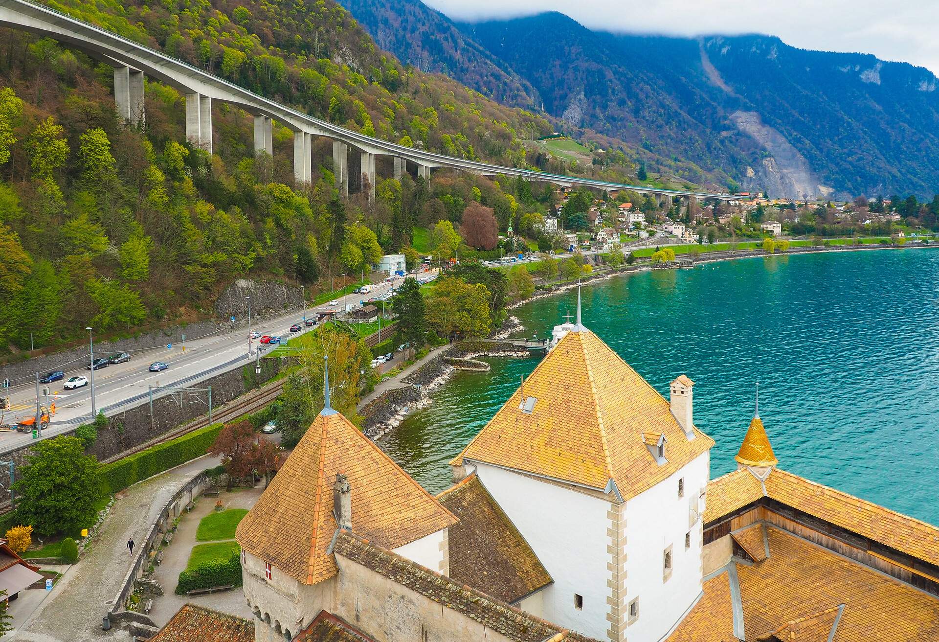 A landscape view from Chillon castle's window, Montreaux,  which is one of the tourist attraction in Switzerland.  It is an ancient castle located beside the  Lake Geneve; Shutterstock ID 653358304