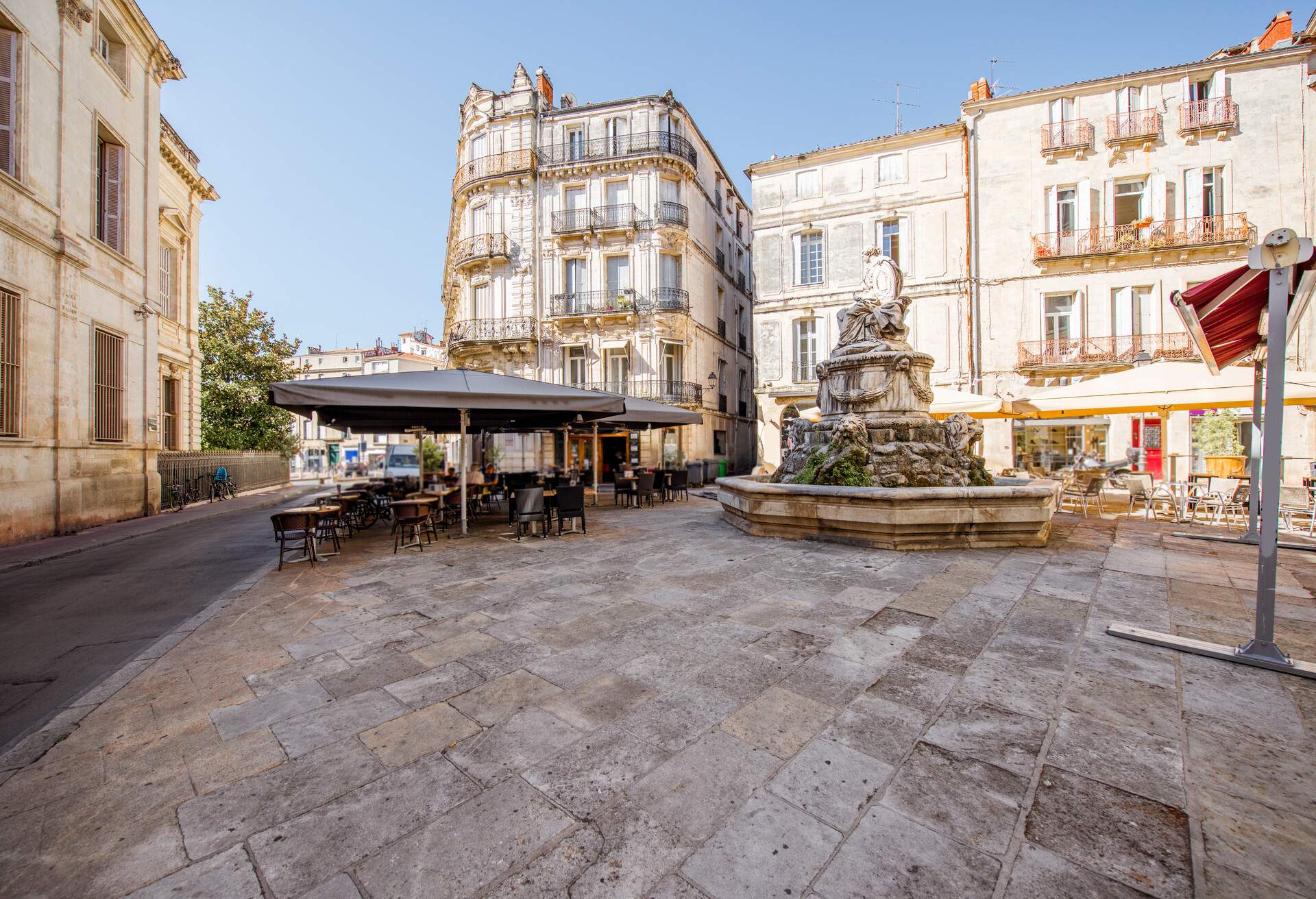 Street view at the old town with cafe terrace in Montpellier city in Occitanie region of France
