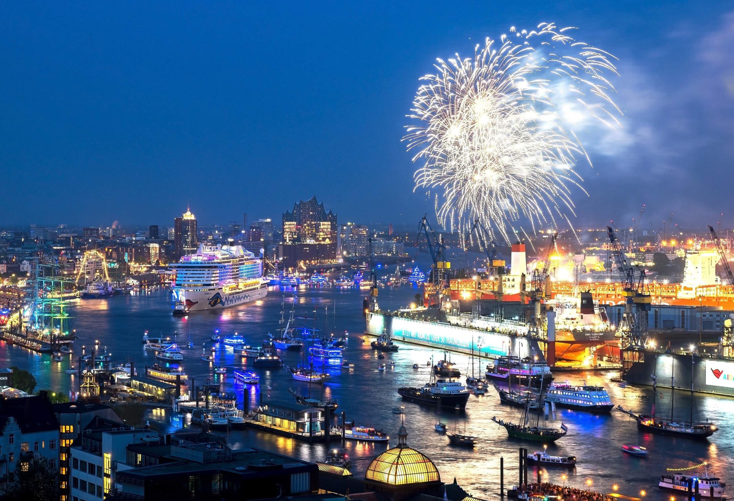 Under the cover of night, the city's bustling harbour is illuminated by a colourful fireworks display.