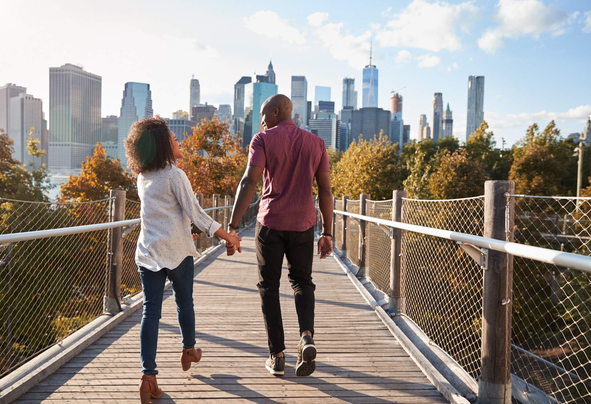 Couple Visiting New York With Manhattan Skyline In Background