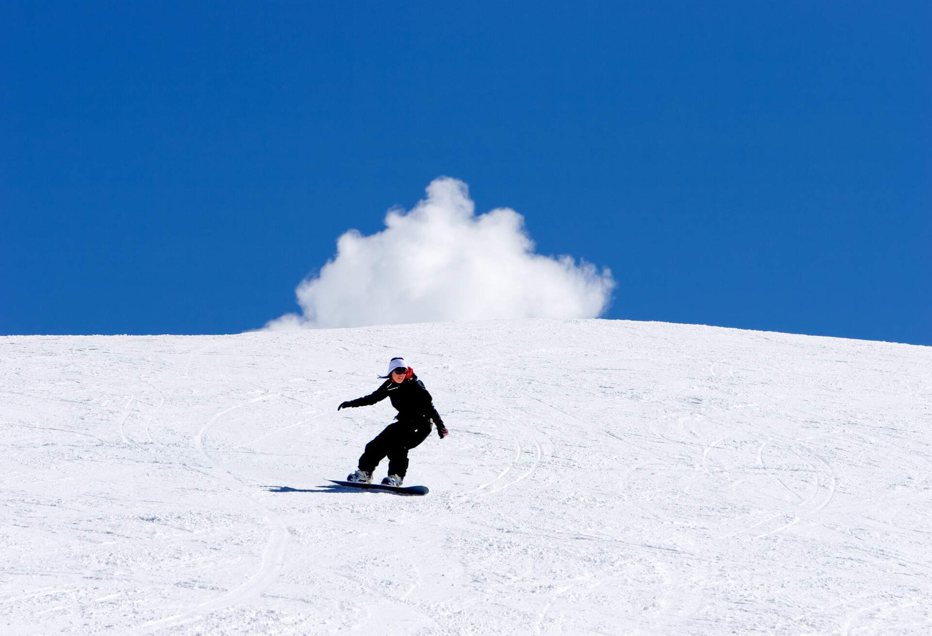 Snowy ski slopes of Pradollano ski resort in the Sierra Nevada mountains in Spain with woman snowboarding; Shutterstock ID 1193340; Purpose: ; Brand (KAYAK, Momondo, Any):