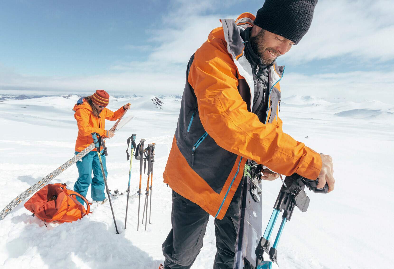 Couple of skiers preparing touring skis for climbing volcano Hekla in Iceland