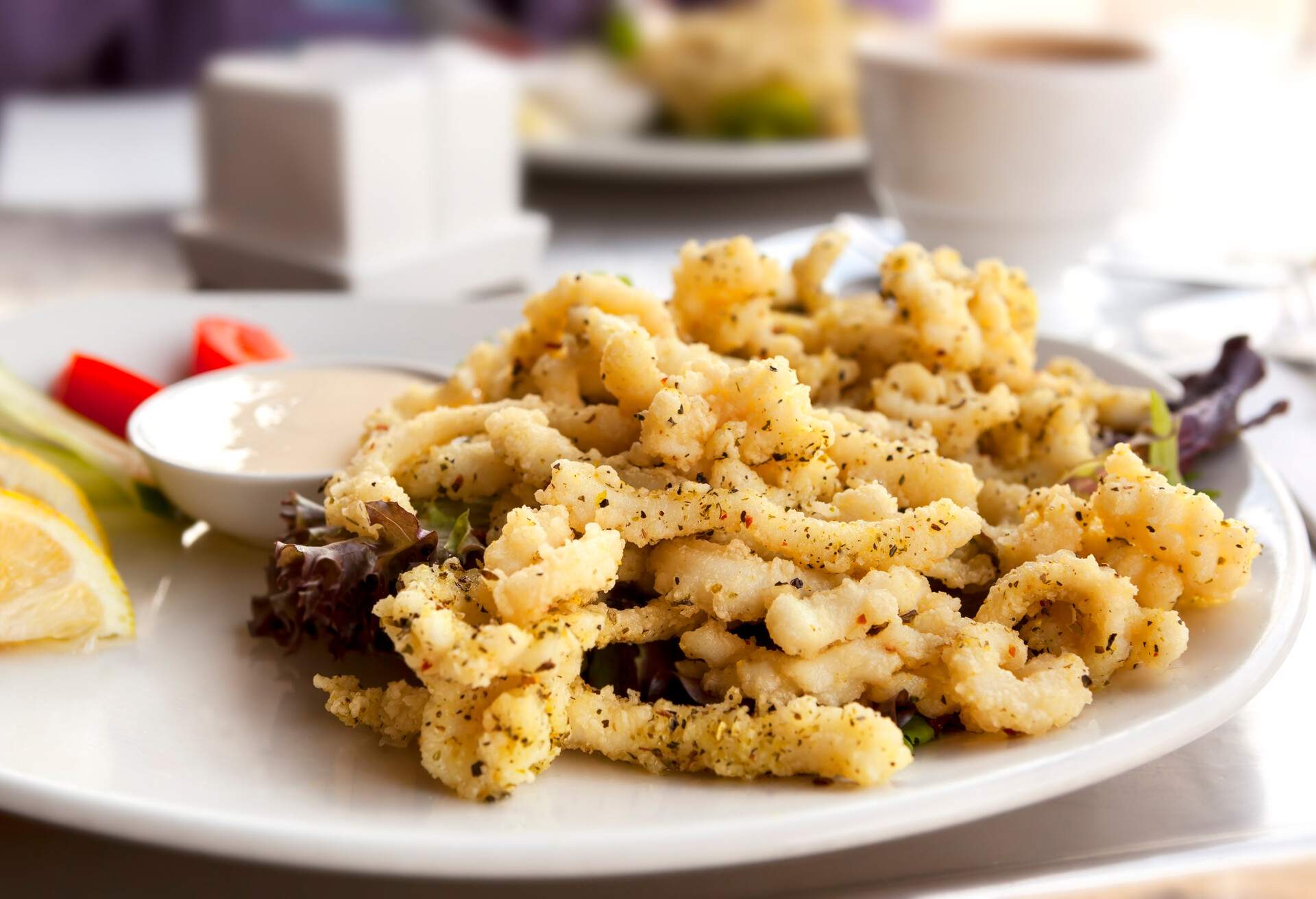 Salt and pepper squid or calamari, with salad, served at sidewalk cafe.