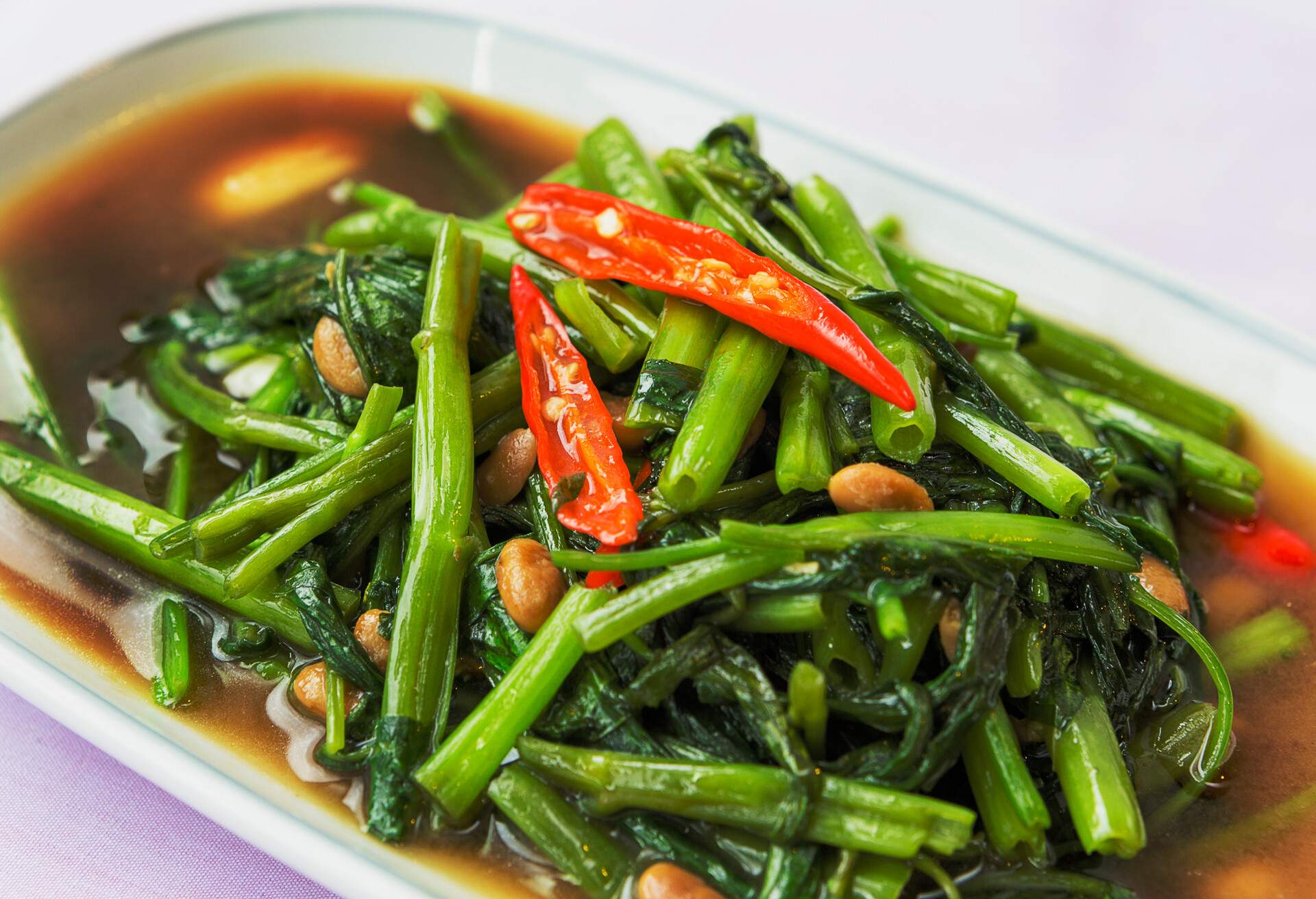 A hot and spicy stir-fried morning glory is a Thai's favorite dish and very easy to make.