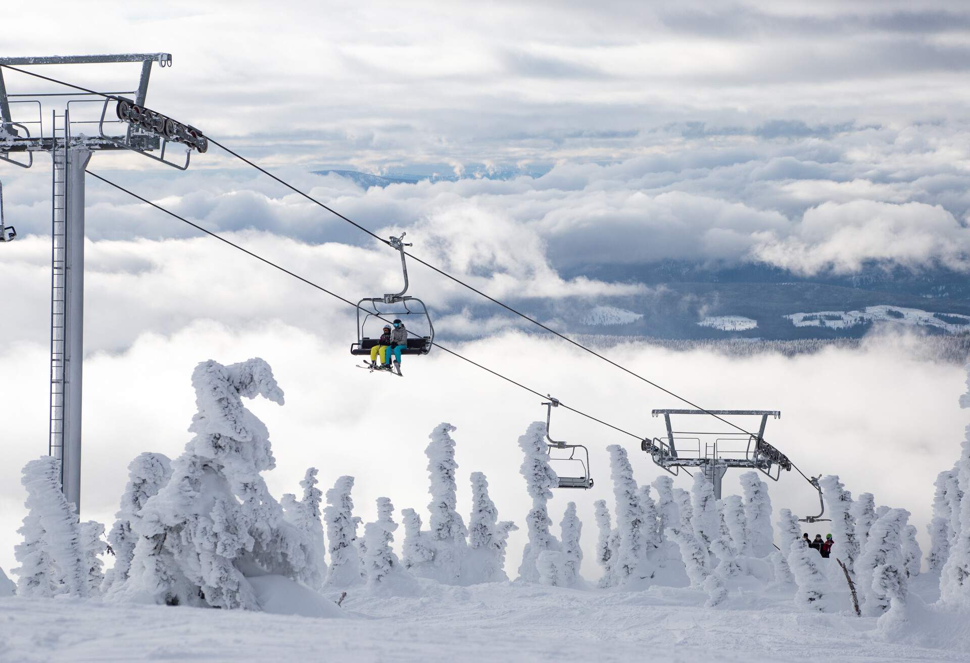Ski or snowboard on chairlift at Big White Resort, Kelowna, British Columbia, Canada; Shutterstock ID 1051495679; Purpose: destiny; Brand (KAYAK, Momondo, Any): any