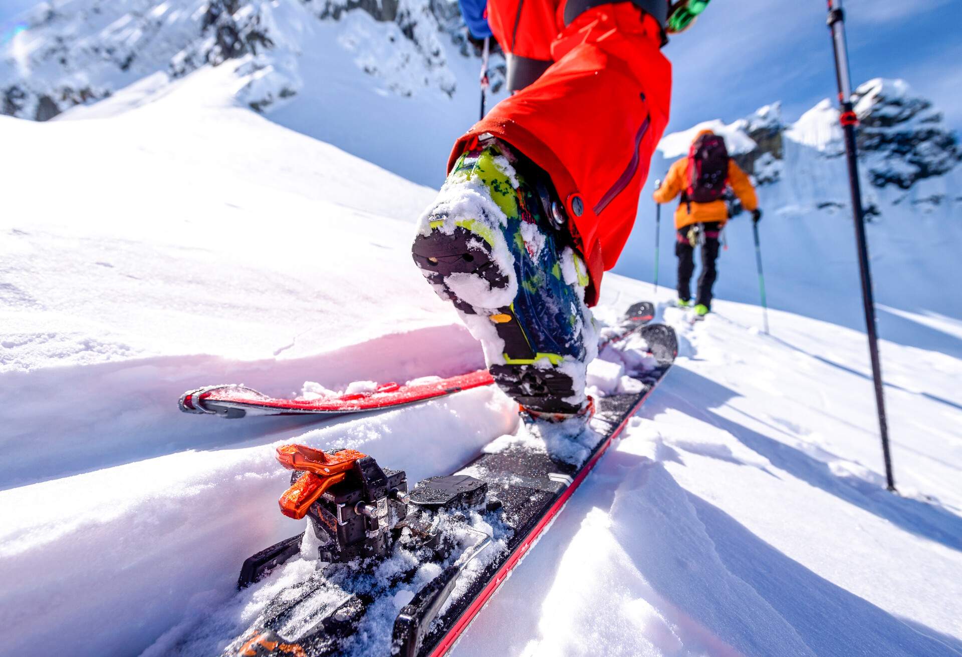 View past skis of man to friend skiing ahead