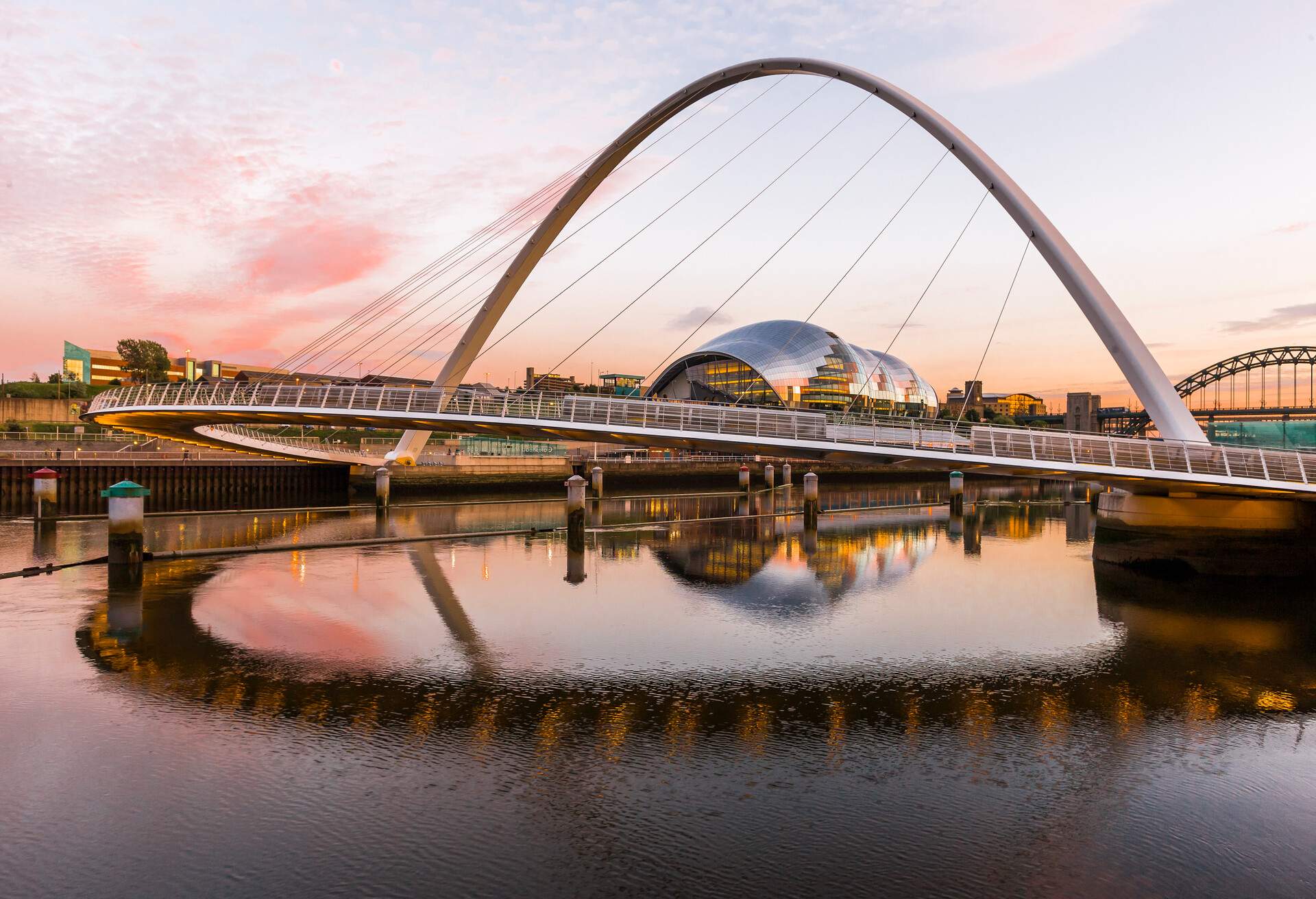 The Gateshead Millennium Bridge (Keith Brownlie, Wilkinson Eyre Architects) between Gateshead and Newcastle upon Tyne and the River Tyne at the sunset, the Sage Gateshead (Norman Foster architect) on the background
