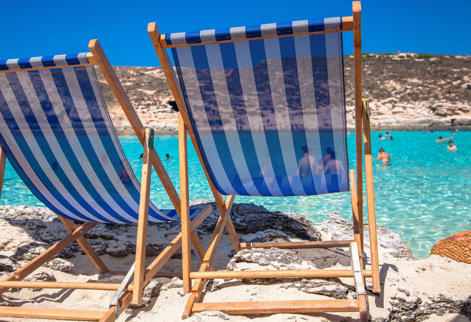 Summer empty beach chair in Bbue Lagoon at Comino island, Malta; Shutterstock ID 393344260
