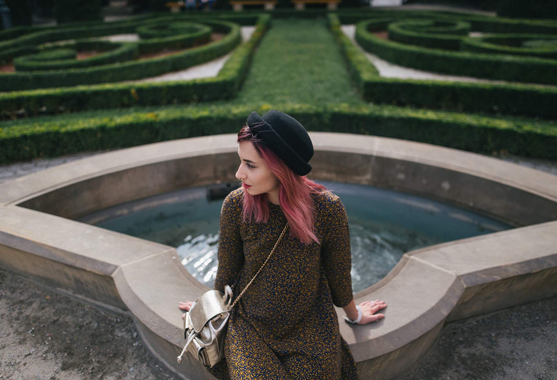 stylish girl with pink hair sitting at fountain in park, Wroclaw, Poland; Shutterstock ID 1018668406