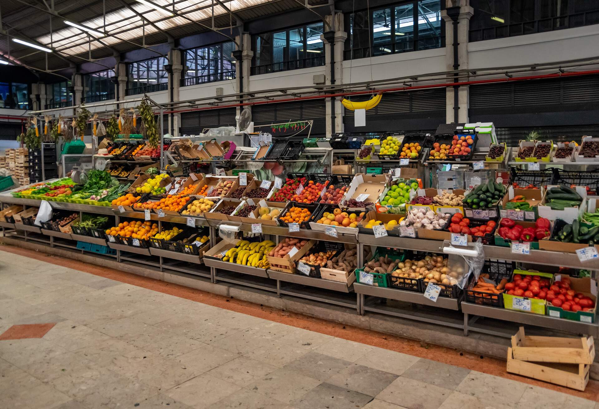 The Ribeira Market is a popular public market by the Cais do Sodre, alongside the Tagus river. Inaugurated in 1882, it has seen good times, and worse, and was handed to the admnistration of private business in 2010, since when it has been a successful gastronomic, cultural and varied market, both for fresh seafood, fruit and vegetables, as for gourmet bites, being a major attraction of Lisbons historic city centre. The image was captured on a calm early summer's day, inside of the fruit and vegetable hall, before the major tourist bustle starts to overcrowd the major sites of Lisbon, later in the summer.